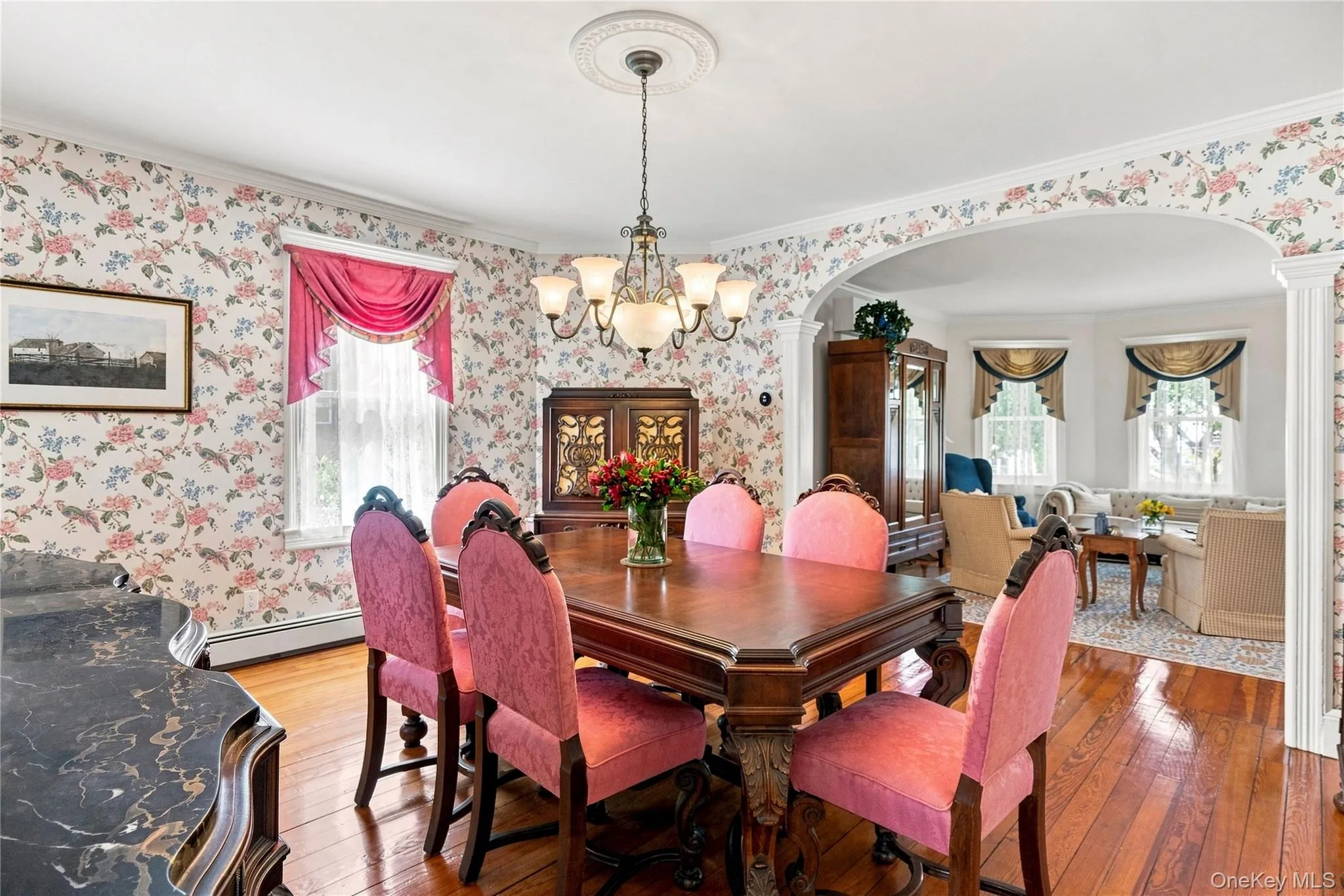 Hardwood flooring, decorative archway, cased openings, chandelier lighting, and crown molding Hardwood flooring, decorative archway, cased openings, chandelier lighting, and crown molding