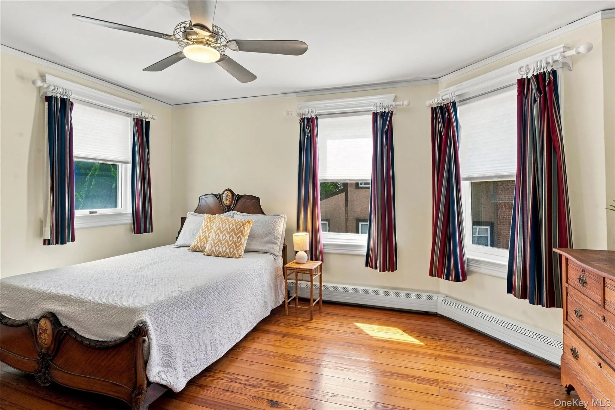 Wood-finish flooring with a ceiling fan and light fixture Wood-finish flooring with a ceiling fan and light fixture
