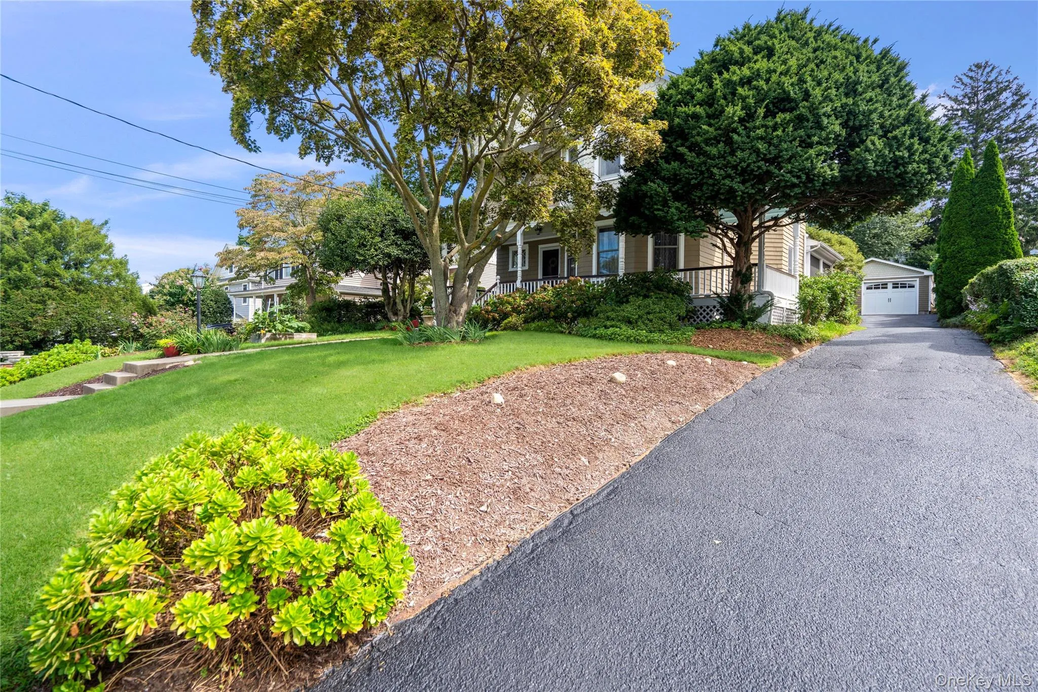 Side of House with paved Driveway Leading to backyard and Detached Garage Side of House with paved Driveway Leading to backyard and Detached Garage