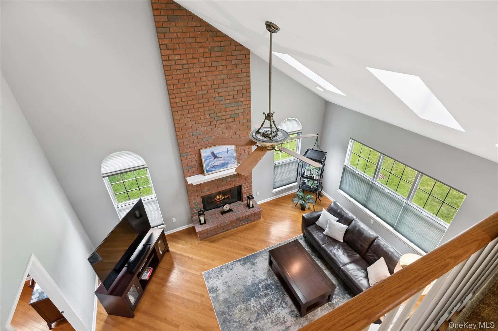Family Room with floor to ceiling brick fireplace & Skylights Family Room with floor to ceiling brick fireplace & Skylights