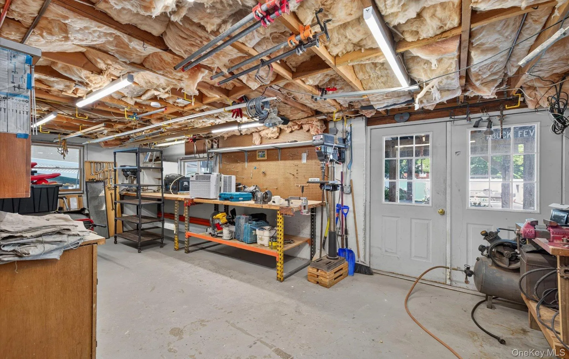 Utility room featuring ,dual exterior doors with glass panels, and built-in shelving Utility room featuring ,dual exterior doors with glass panels, and built-in shelving