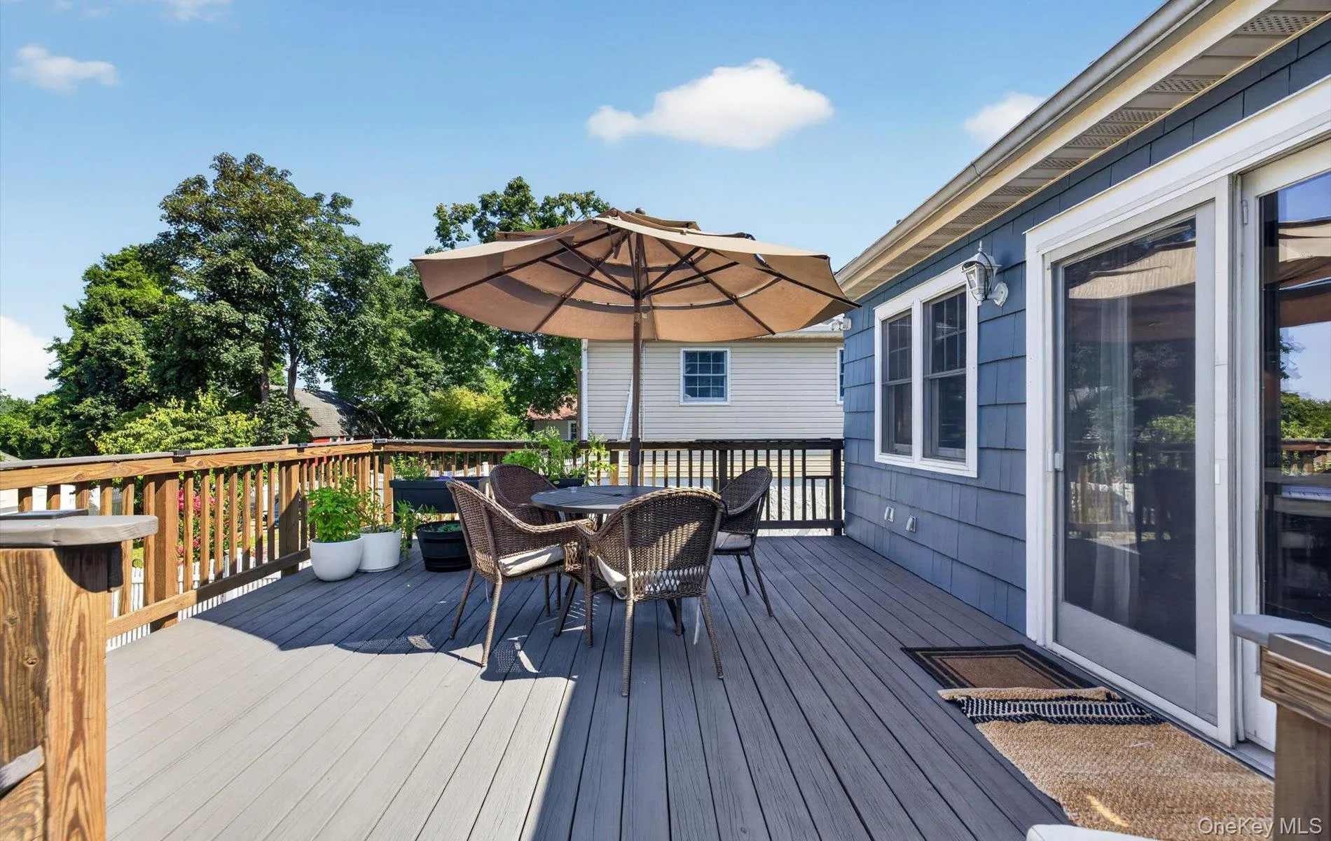 Spacious outdoor deck , a natural wood railing, and direct access to the interior via a sliding glass door Spacious outdoor deck , a natural wood railing, and direct access to the interior via a sliding glass door