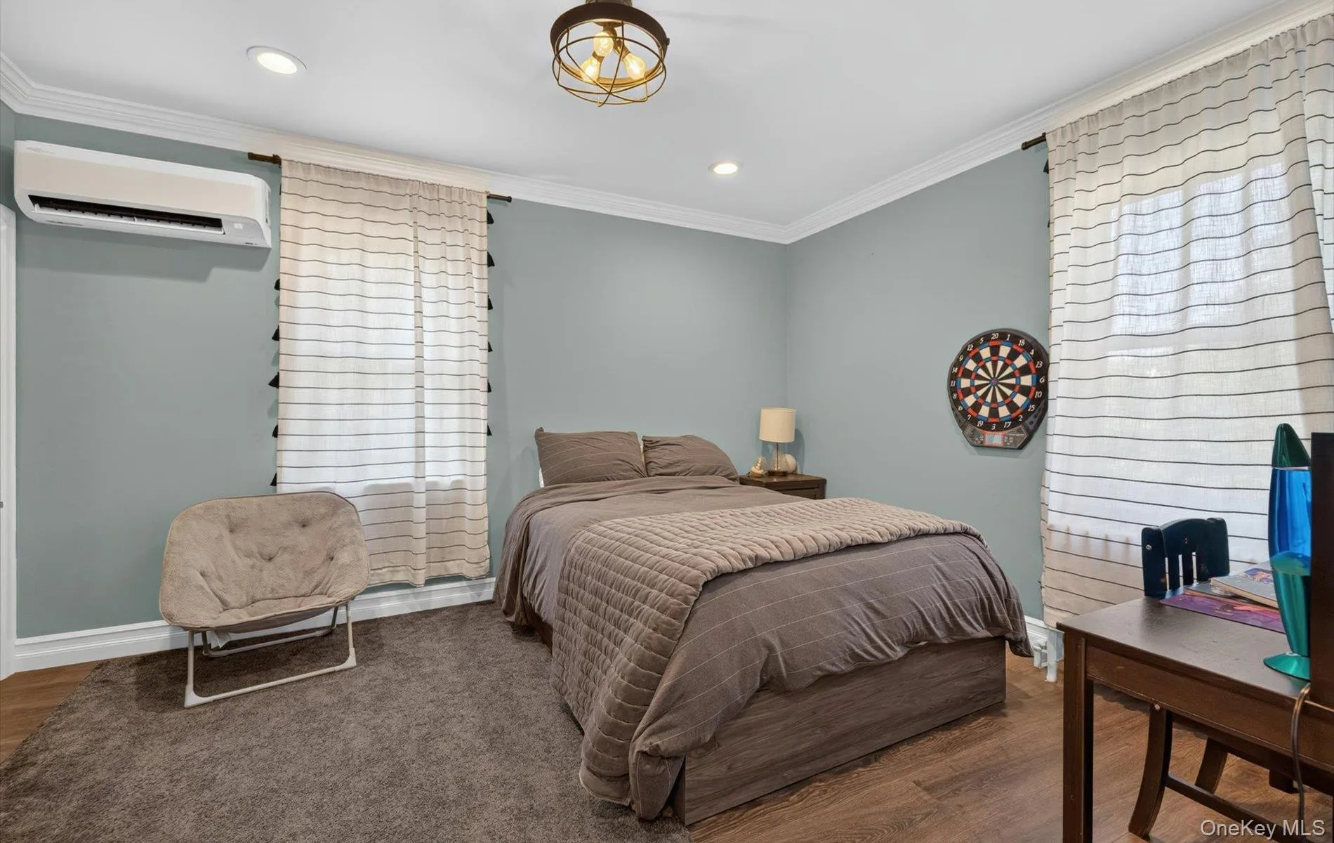Bedroom featuring wood-finish flooring, New Ductless AC Bedroom featuring wood-finish flooring, New Ductless AC