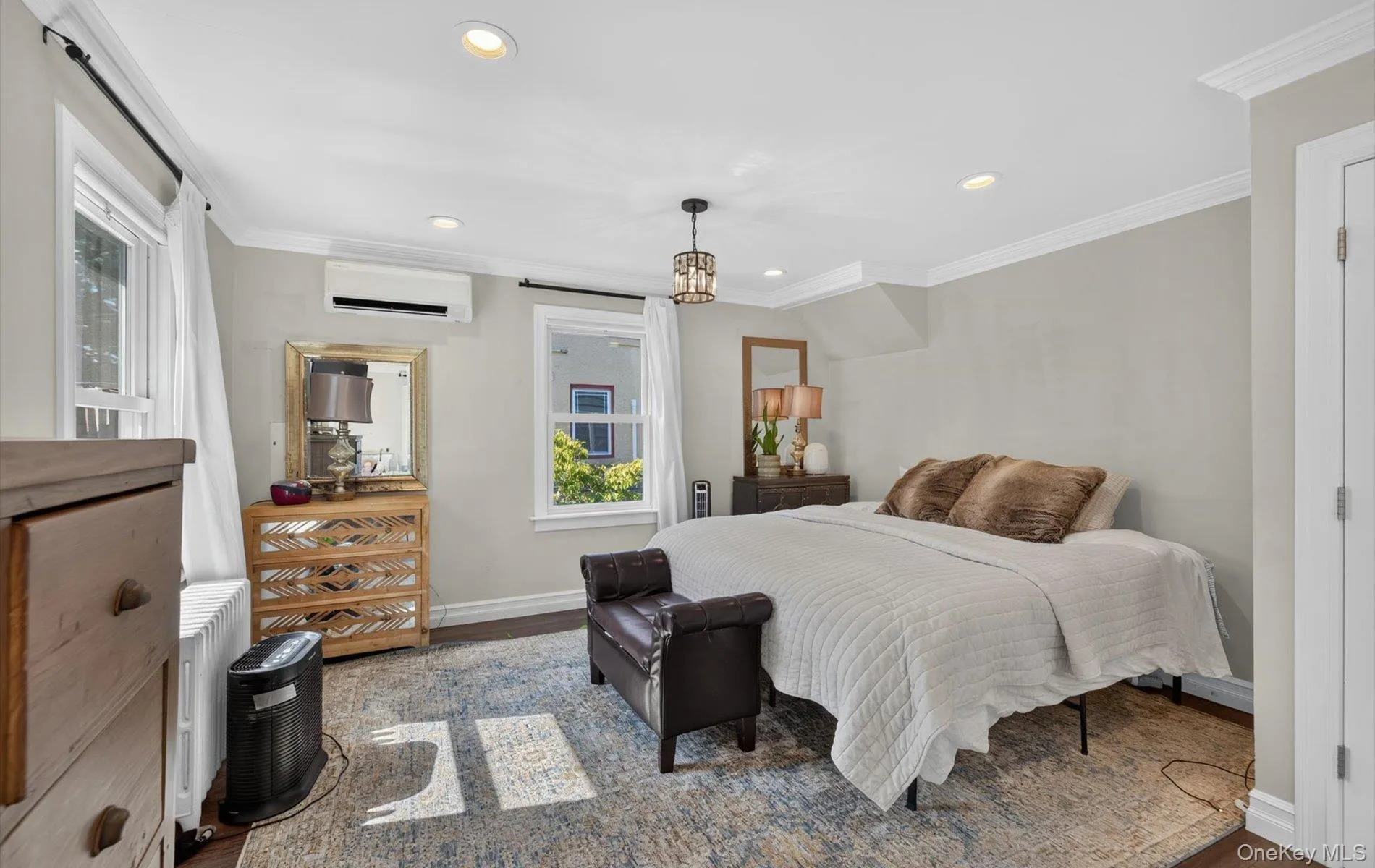 Bedroom featuring wood-finish flooring, recessed lighting, and crown molding, New ductless AC Bedroom featuring wood-finish flooring, recessed lighting, and crown molding, New ductless AC