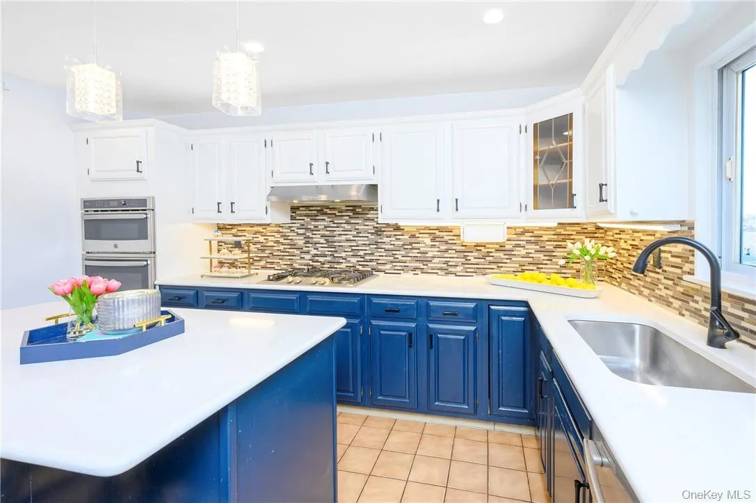 The kitchen features quartz counters and a center island. The kitchen features quartz counters and a center island.