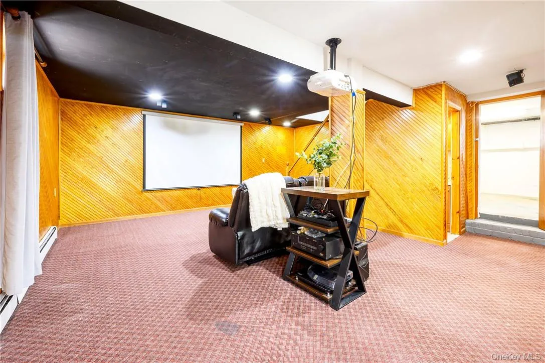View of the walkout lower level with unfinished storage and a powder room on the right. View of the walkout lower level with unfinished storage and a powder room on the right.