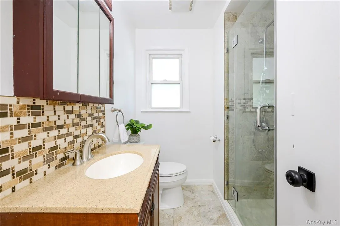 Renovated bathroom on main level with shower. Renovated bathroom on main level with shower.