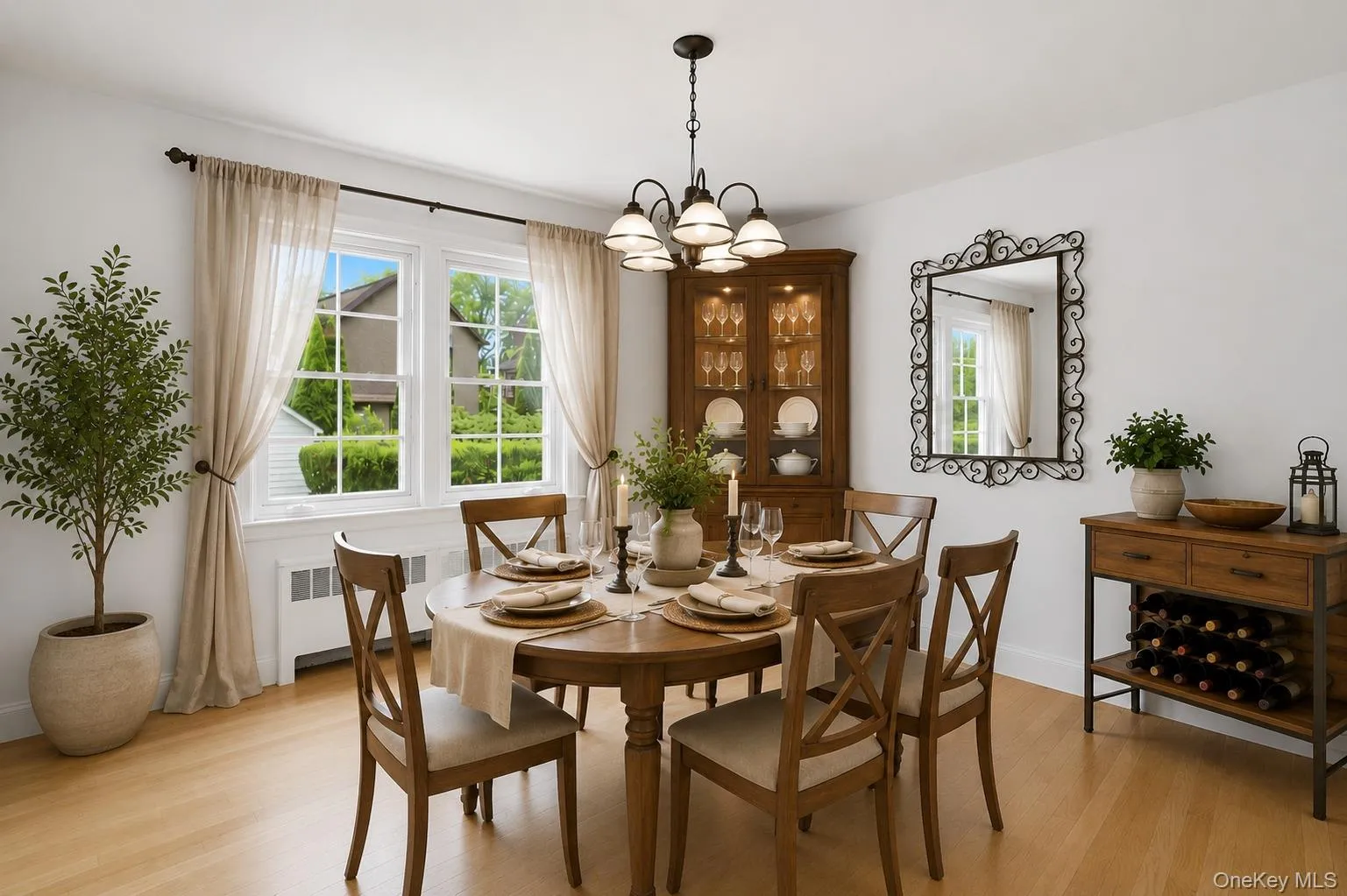 Bright dining area featuring wood-finish flooring, a multi-pane window Bright dining area featuring wood-finish flooring, a multi-pane window