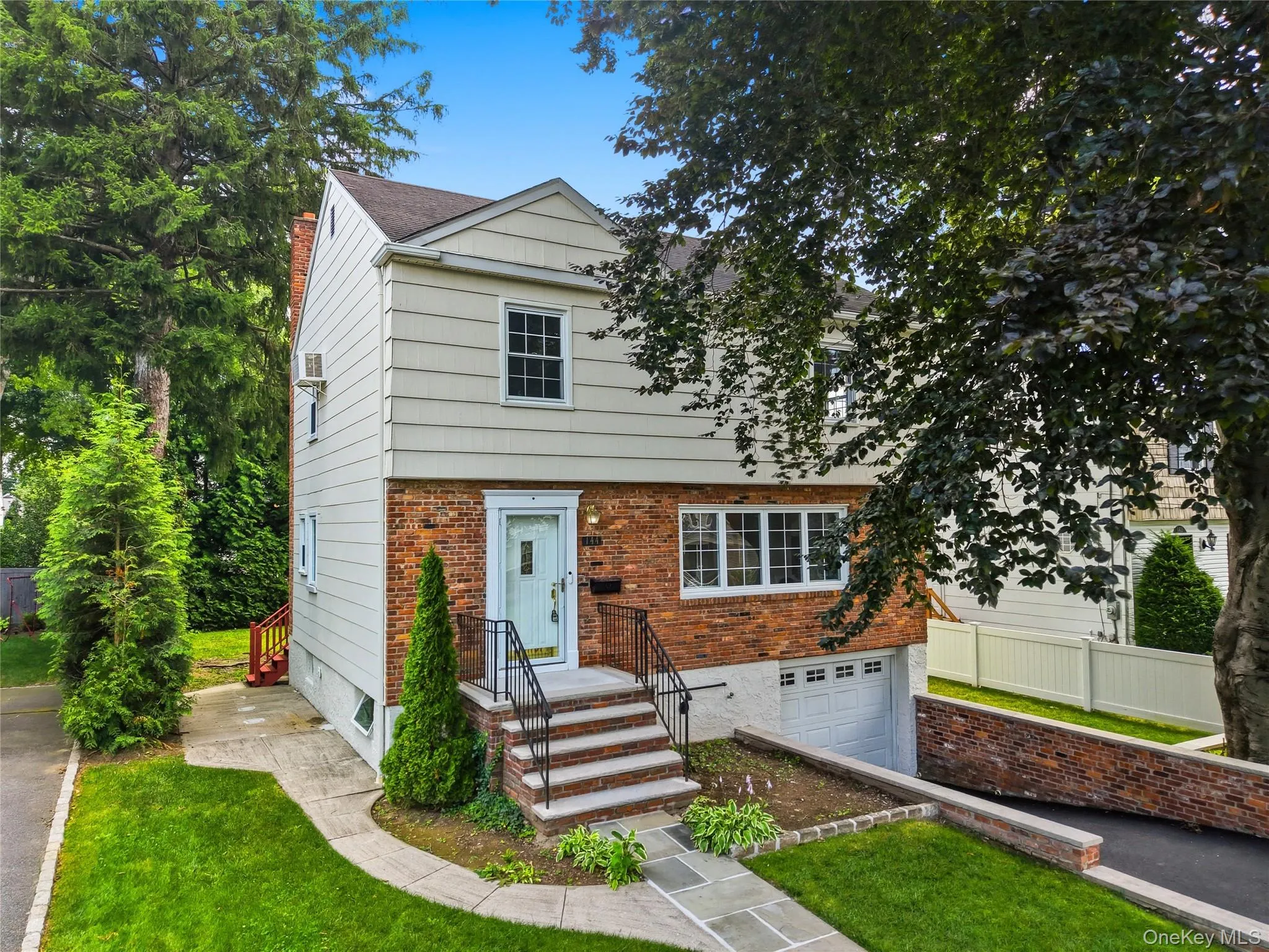 Two-story residence featuring a brick and siding facade Two-story residence featuring a brick and siding facade