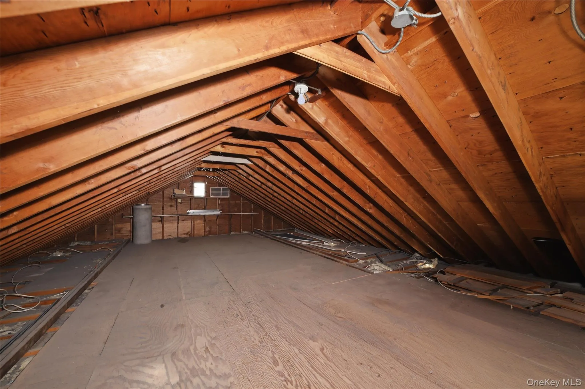 Spacious attic featuring exposed wood beams and a large subfloor area Spacious attic featuring exposed wood beams and a large subfloor area