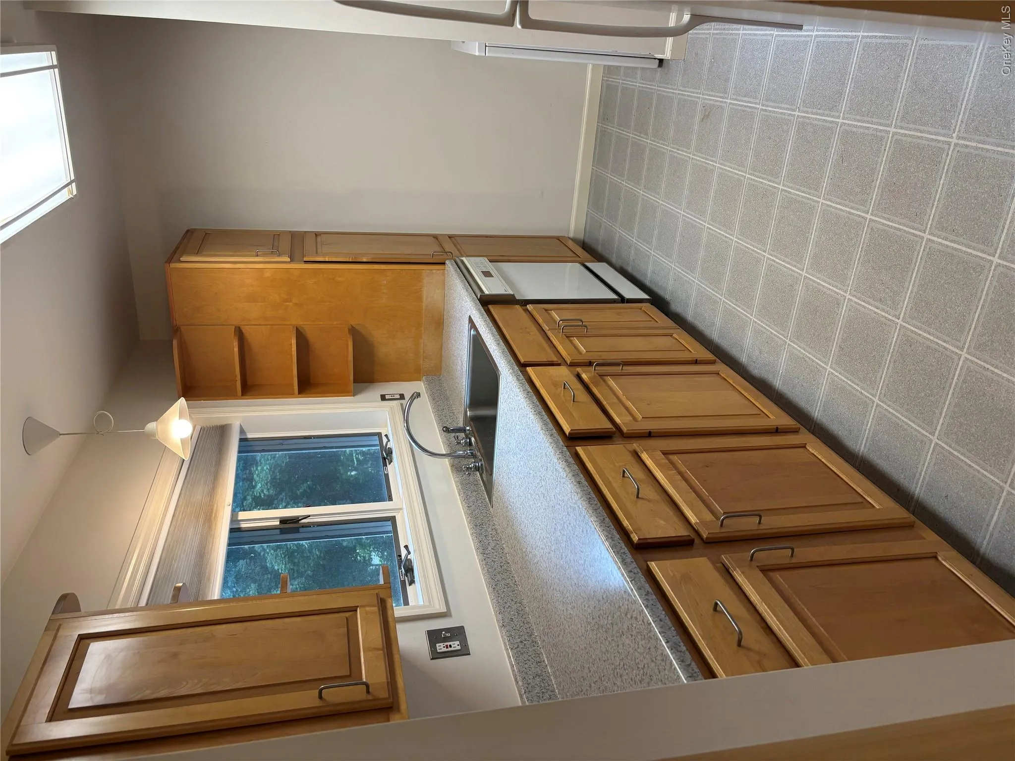 Kitchen featuring light wood cabinetry, and stainless steel sink Kitchen featuring light wood cabinetry, and stainless steel sink