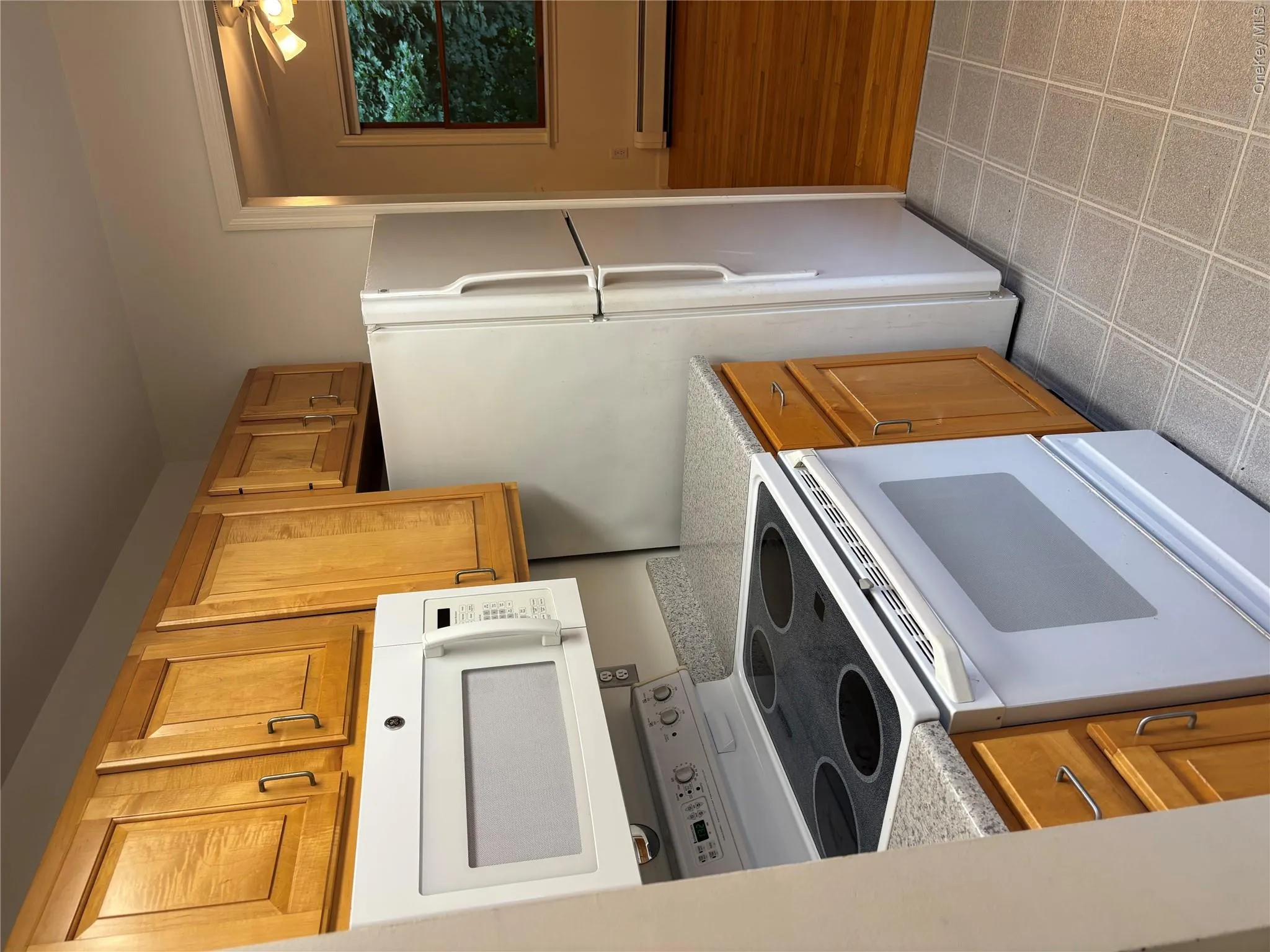 Kitchen with built-in microwave, an electric range, and a refrigerator Kitchen with built-in microwave, an electric range, and a refrigerator