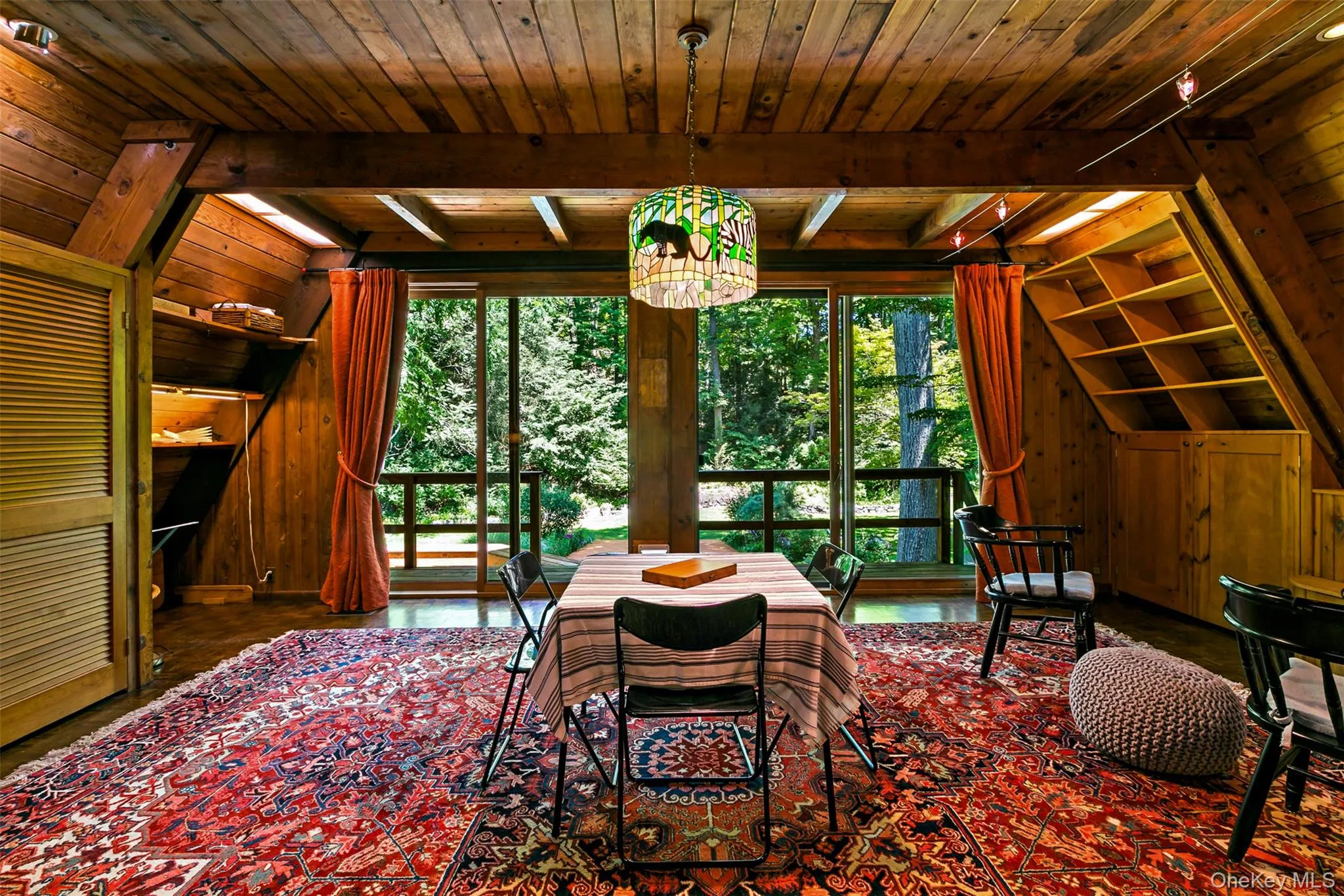 Another angle of recreation room highlighting the A frame features of the house. Another angle of recreation room highlighting the A frame features of the house.