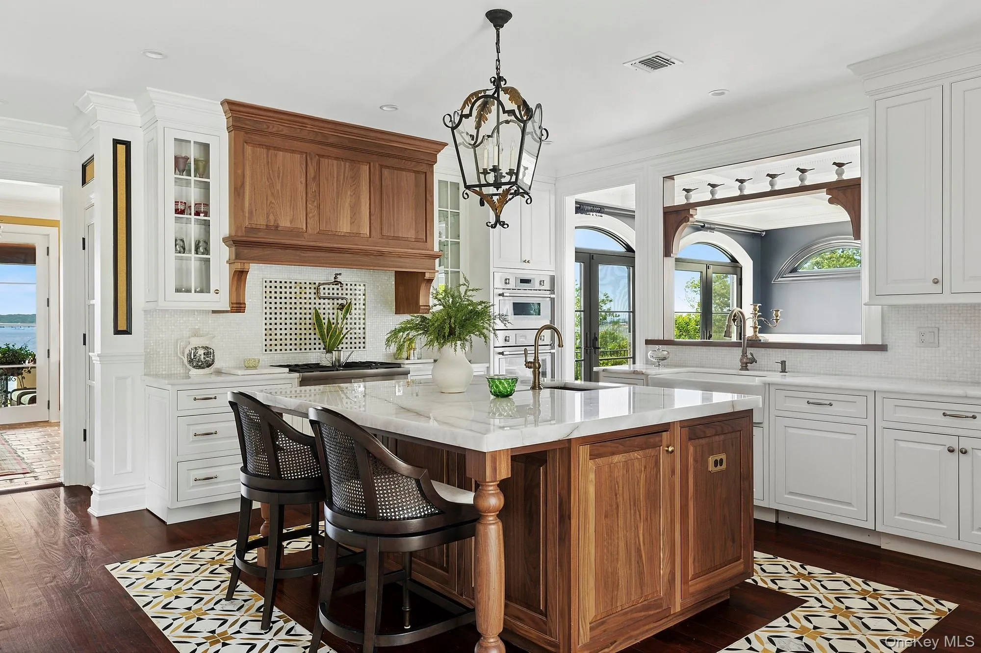 Kitchen featuring backsplash, custom cabinetry, plenty of natural light, ornamental molding, and recessed lighting Kitchen featuring backsplash, custom cabinetry, plenty of natural light, ornamental molding, and recessed lighting