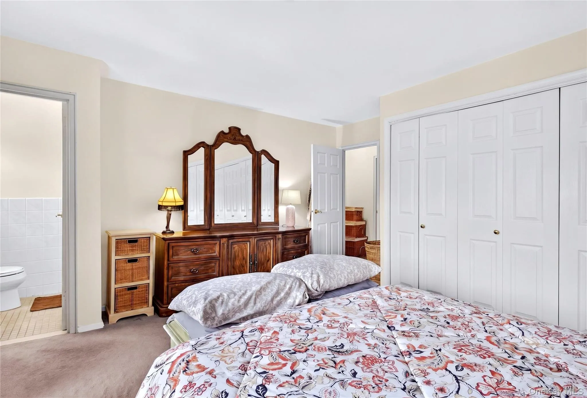 View of primary bedroom with entrance to primary bath. View of primary bedroom with entrance to primary bath.