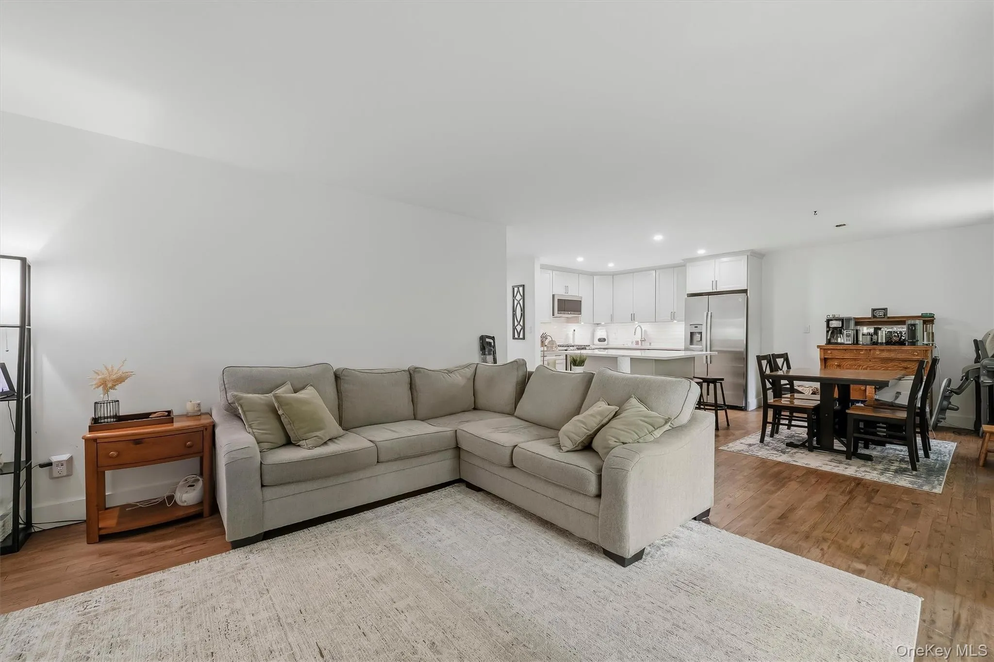 Open-concept living space with wood-finish flooring Open-concept living space with wood-finish flooring