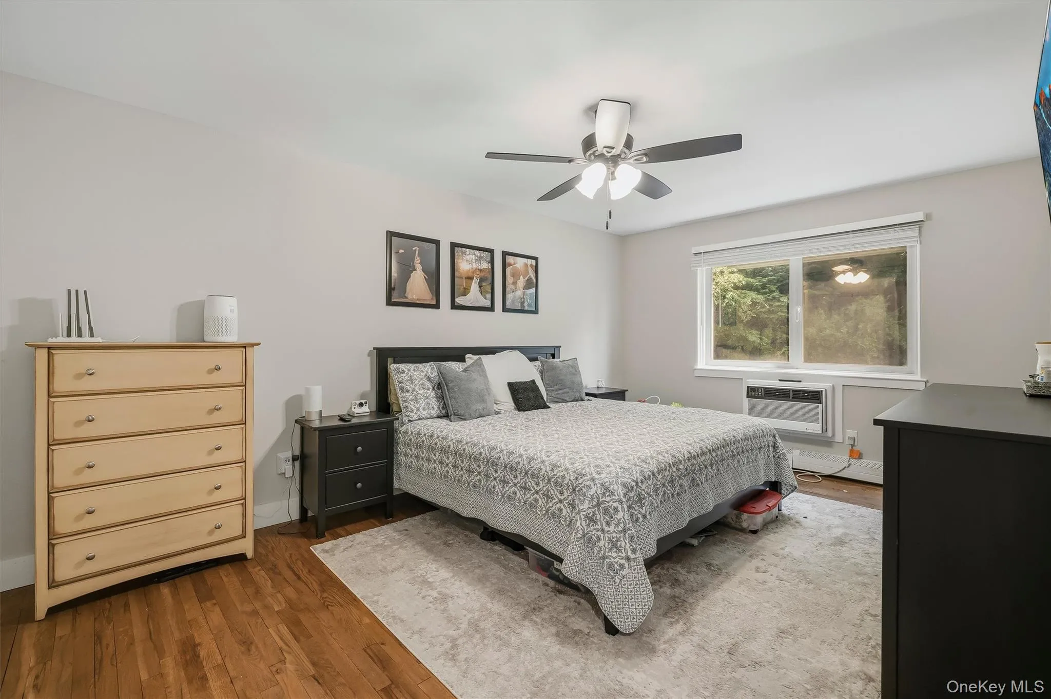 Hardwood-style flooring extends throughout this room, complemented by neutral wall tones Hardwood-style flooring extends throughout this room, complemented by neutral wall tones