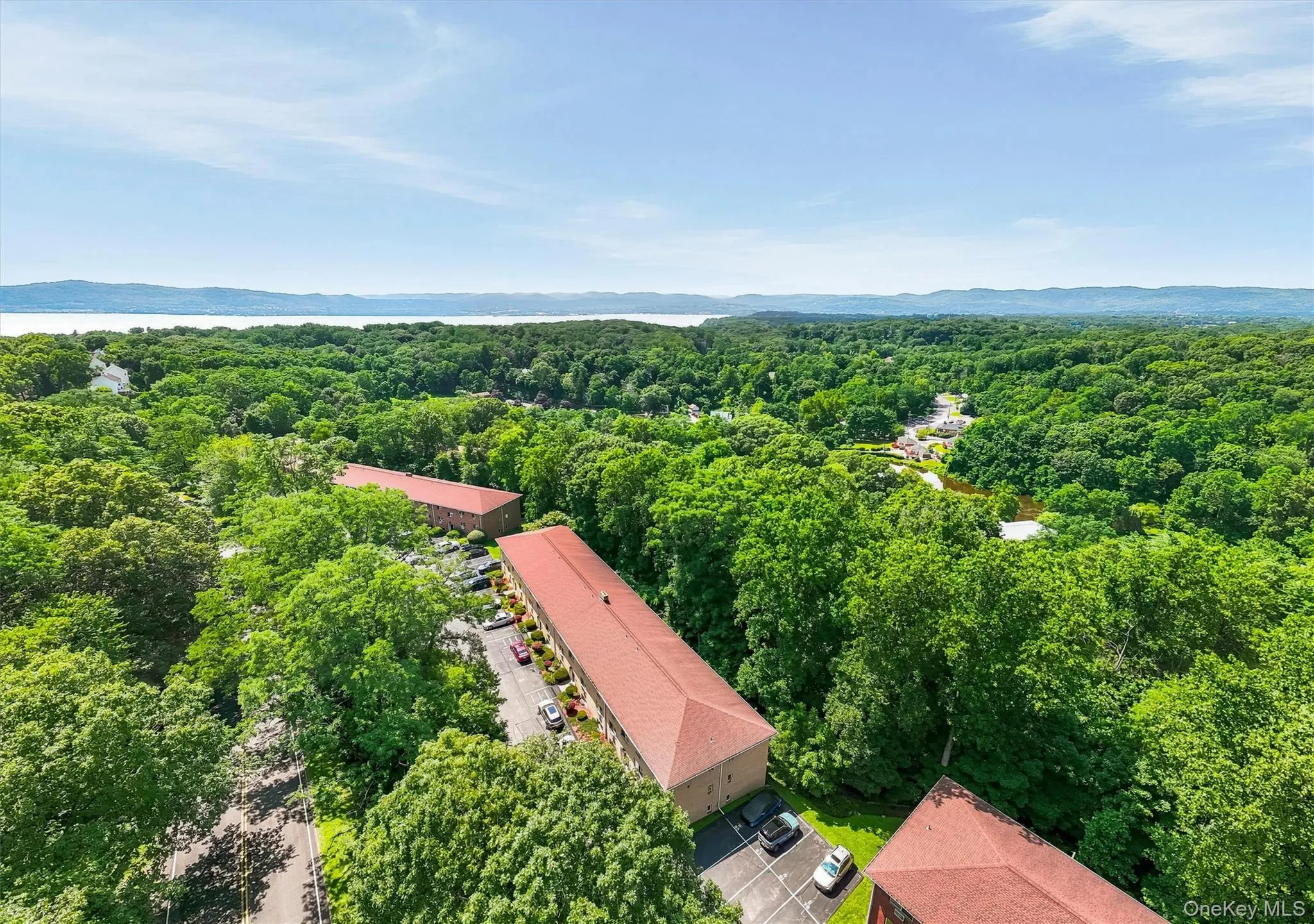 Aerial view showcasing this expansive property nestled within mature tree canopy Aerial view showcasing this expansive property nestled within mature tree canopy