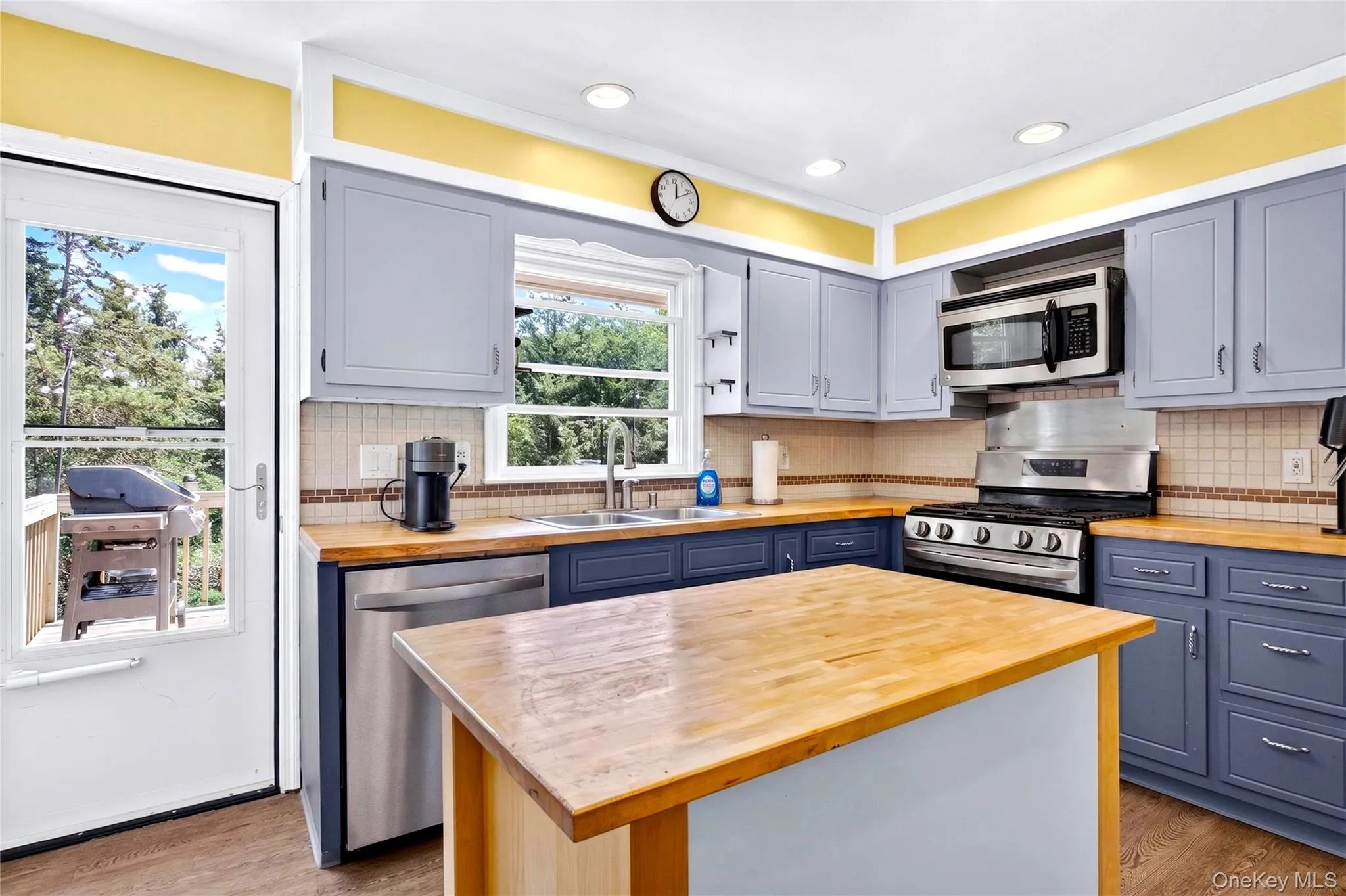 Kitchen with door to large deck. Kitchen with door to large deck.