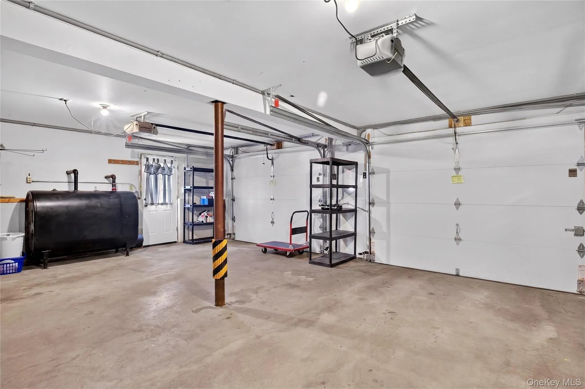 Two car garage with new efficient remote doors. Two car garage with new efficient remote doors.