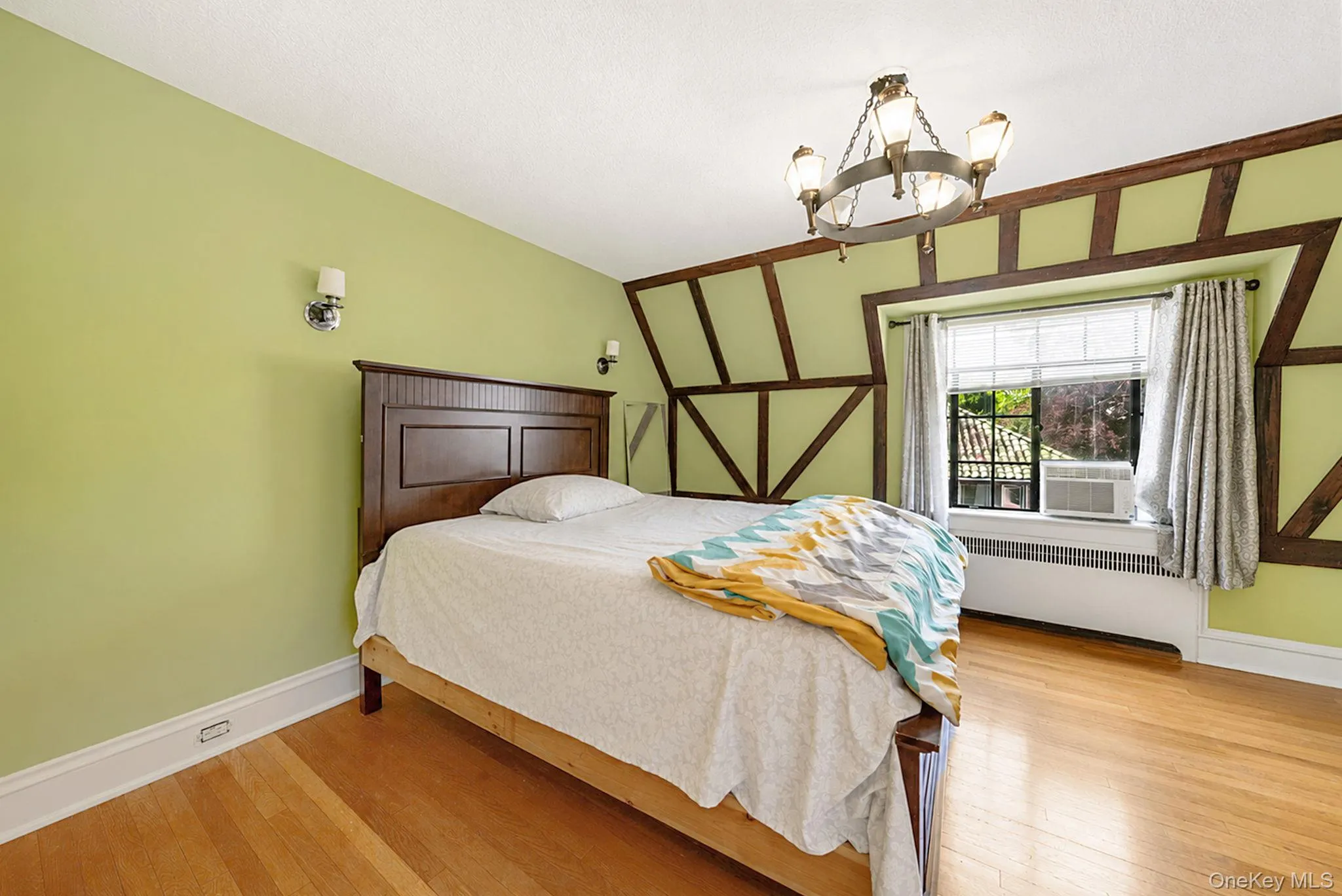 Bedroom featuring exposed timber framing and light wood-finish flooring Bedroom featuring exposed timber framing and light wood-finish flooring