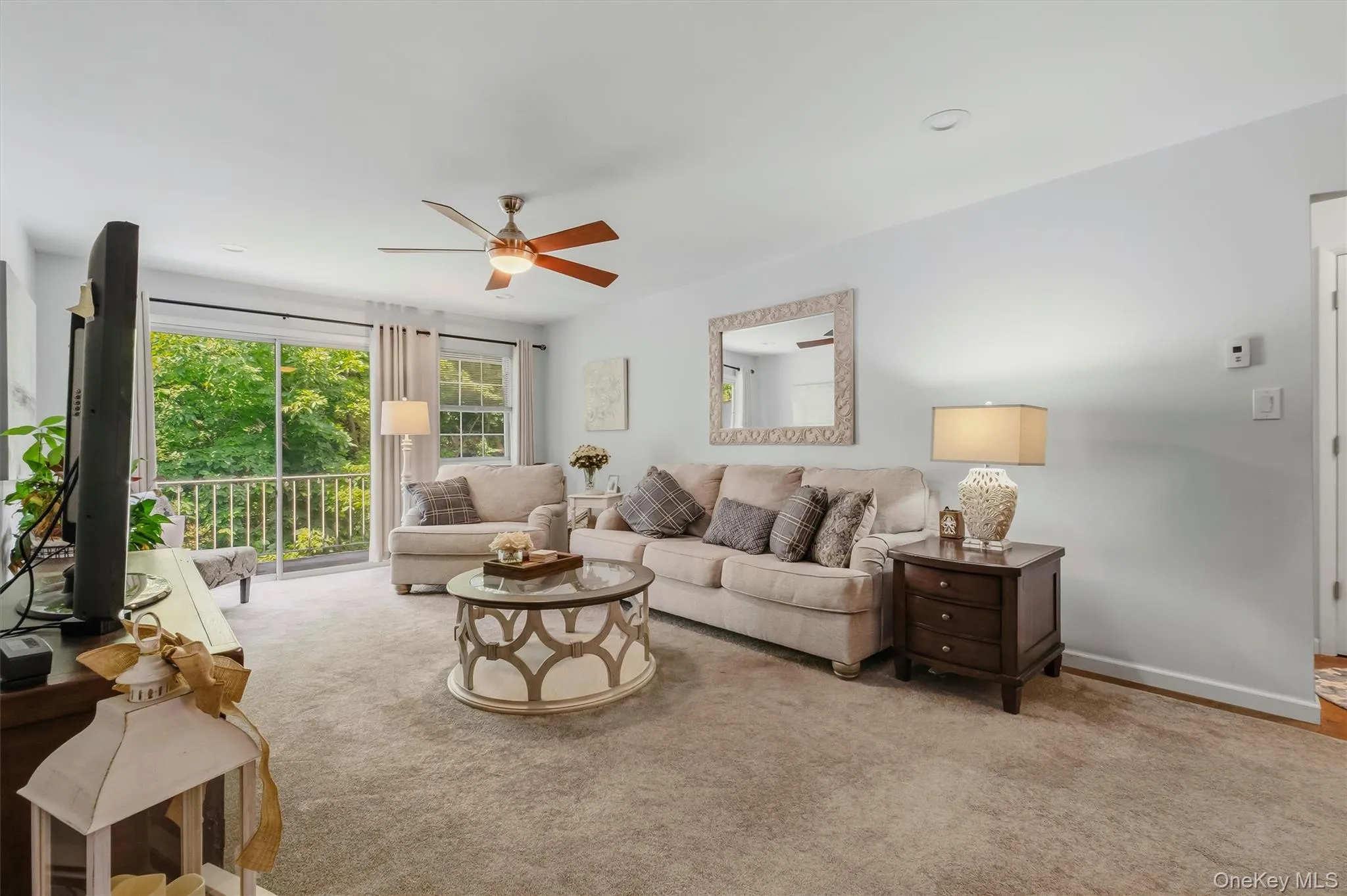 Spacious living room with sliding glass door to private balcony. Spacious living room with sliding glass door to private balcony.