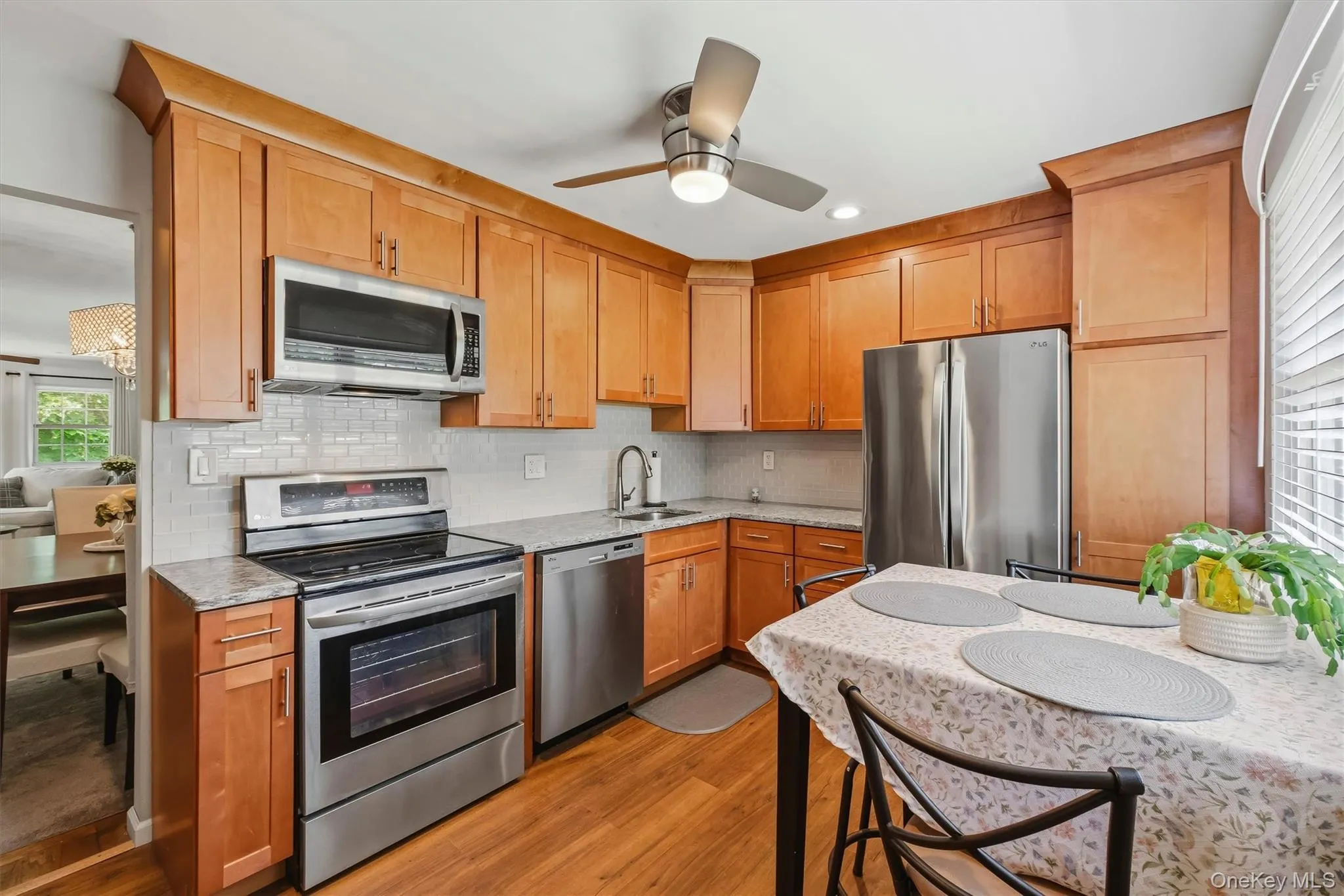 Updated kitchen with custom cabinets, stainless steel appliances, and hardwood flooring. Updated kitchen with custom cabinets, stainless steel appliances, and hardwood flooring.