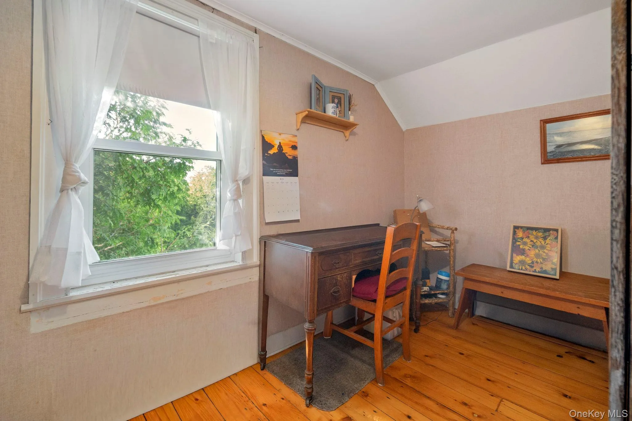 Hardwood flooring complements textured wall finishes in this room featuring a prominent window Hardwood flooring complements textured wall finishes in this room featuring a prominent window