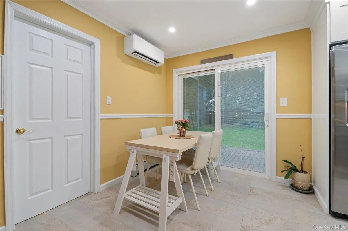 Large Dining Area with Pella Sliders to Yard and Main Level Laundry Access/ Large Dining Area with Pella Sliders to Yard and Main Level Laundry Access/