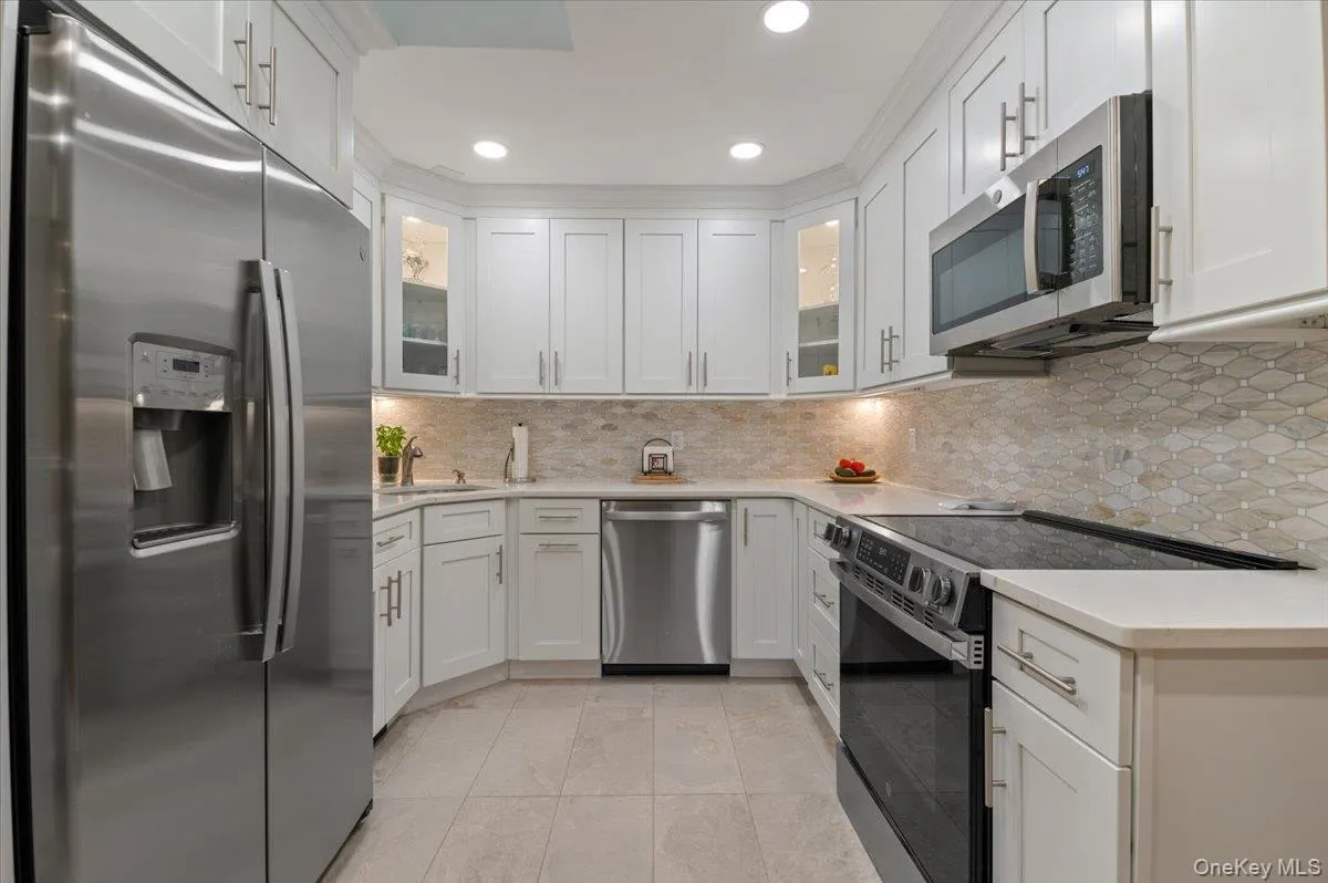 Brand New Top of the Line Stainless Steel Appliances are accented with Mosaic Ceramic Backsplash and Quartz Countertops with Plenty of Room for Meal Prep and Storage. Brand New Top of the Line Stainless Steel Appliances are accented with Mosaic Ceramic Backsplash and Quartz Countertops with Plenty of Room for Meal Prep and Storage.