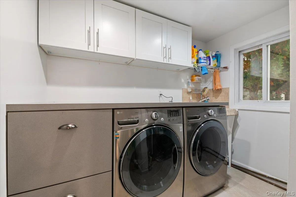Main Level Laundry with New Washer and Dryer with built in Laundry sorter and lots of storage and work area. Main Level Laundry with New Washer and Dryer with built in Laundry sorter and lots of storage and work area.