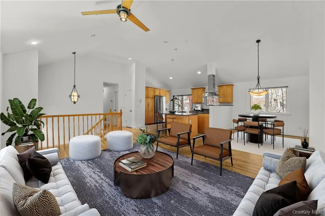 Virtually staged view of the living room, dining room and kitchen. Virtually staged view of the living room, dining room and kitchen.