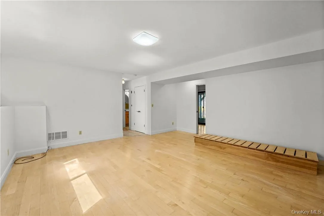 View of the family room. Laundry closet is in the center and full bath beyond that. Office is on the right. View of the family room. Laundry closet is in the center and full bath beyond that. Office is on the right.