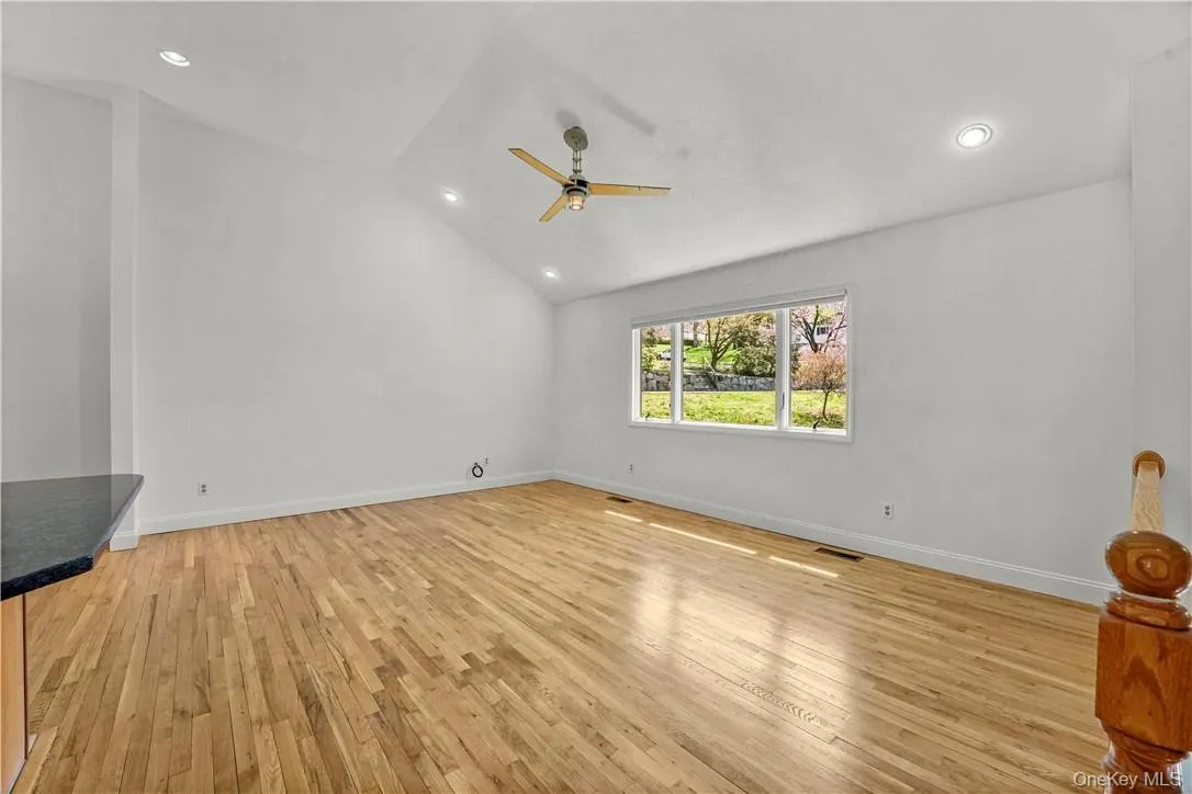 Living Room with Cathedral Ceiling. Kitchen on the left. Living Room with Cathedral Ceiling. Kitchen on the left.