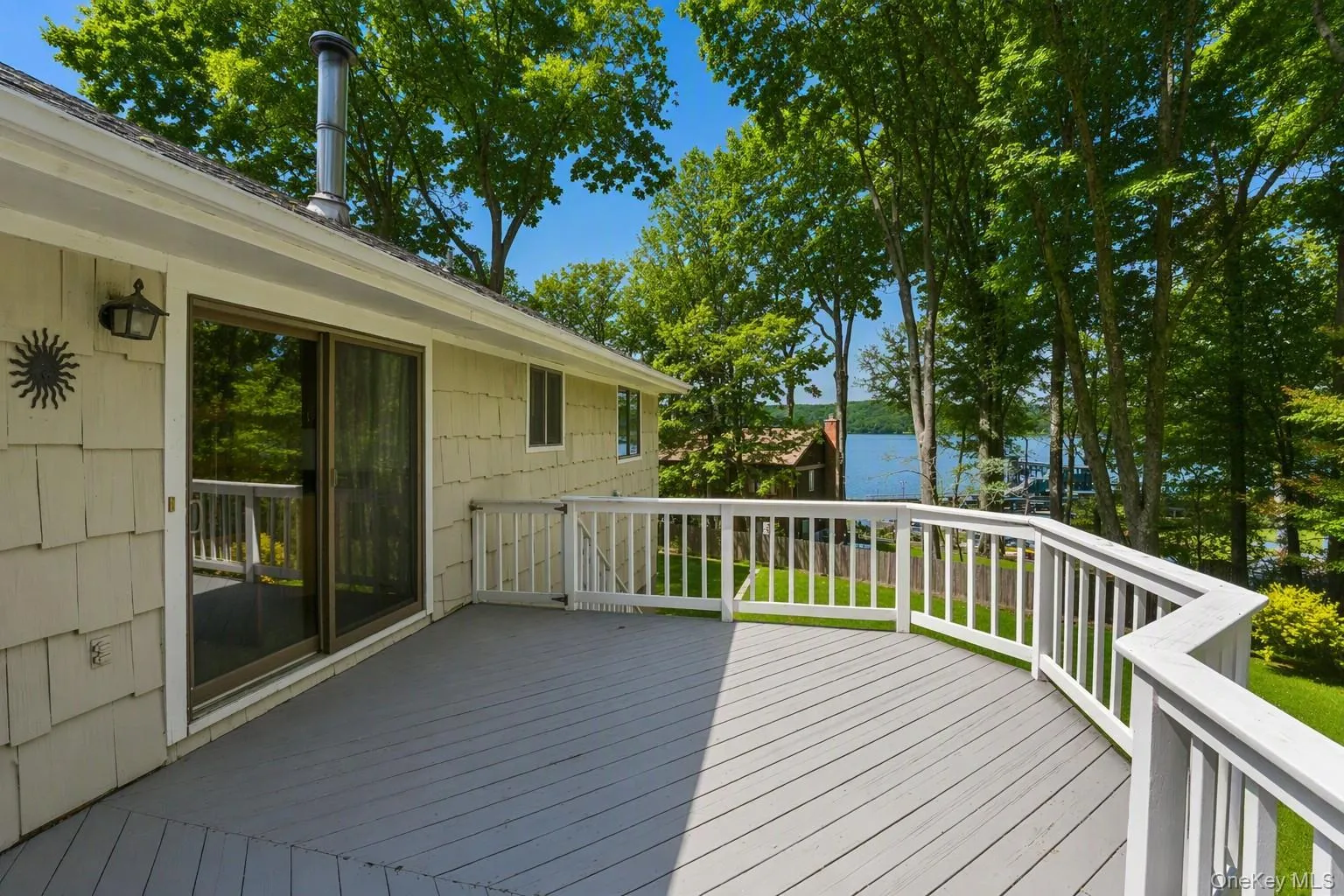Sliding glass door from kitchen to deck overlooking yard and Hudson River. Sliding glass door from kitchen to deck overlooking yard and Hudson River.
