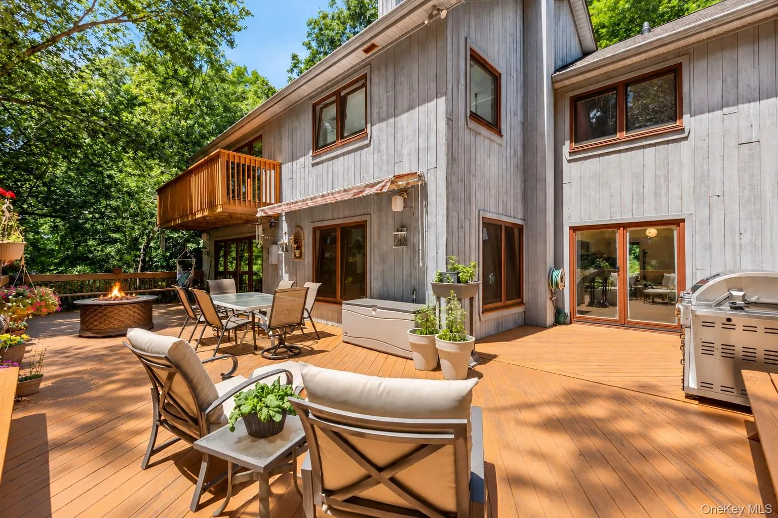 A wraparound deck extends seamlessly from the main-level living space, creating an inviting outdoor extension where thoughtful design and nature beautifully come together, enhanced by the warm ambiance of the firepit. A wraparound deck extends seamlessly from the main-level living space, creating an inviting outdoor extension where thoughtful design and nature beautifully come together, enhanced by the warm ambiance of the firepit.