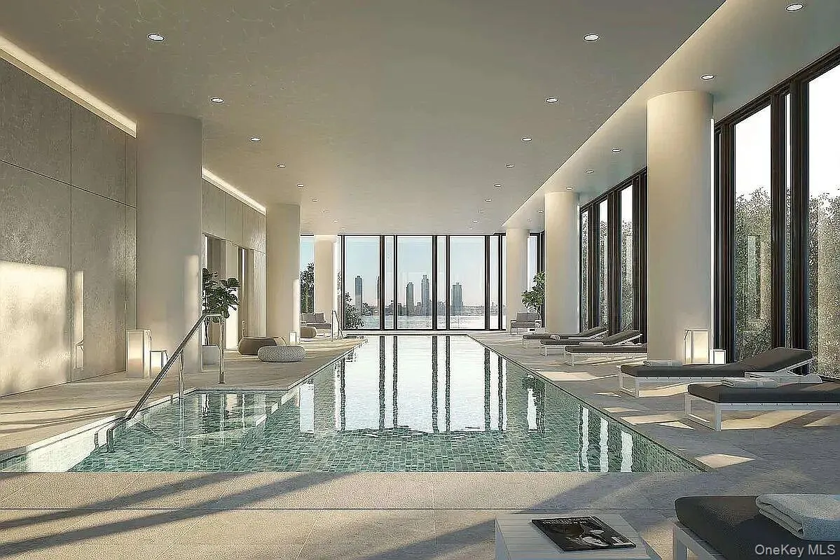 Indoor swimming pool featuring floor-to-ceiling windows, recessed lighting, tile flooring, and a cityscape backdrop Indoor swimming pool featuring floor-to-ceiling windows, recessed lighting, tile flooring, and a cityscape backdrop