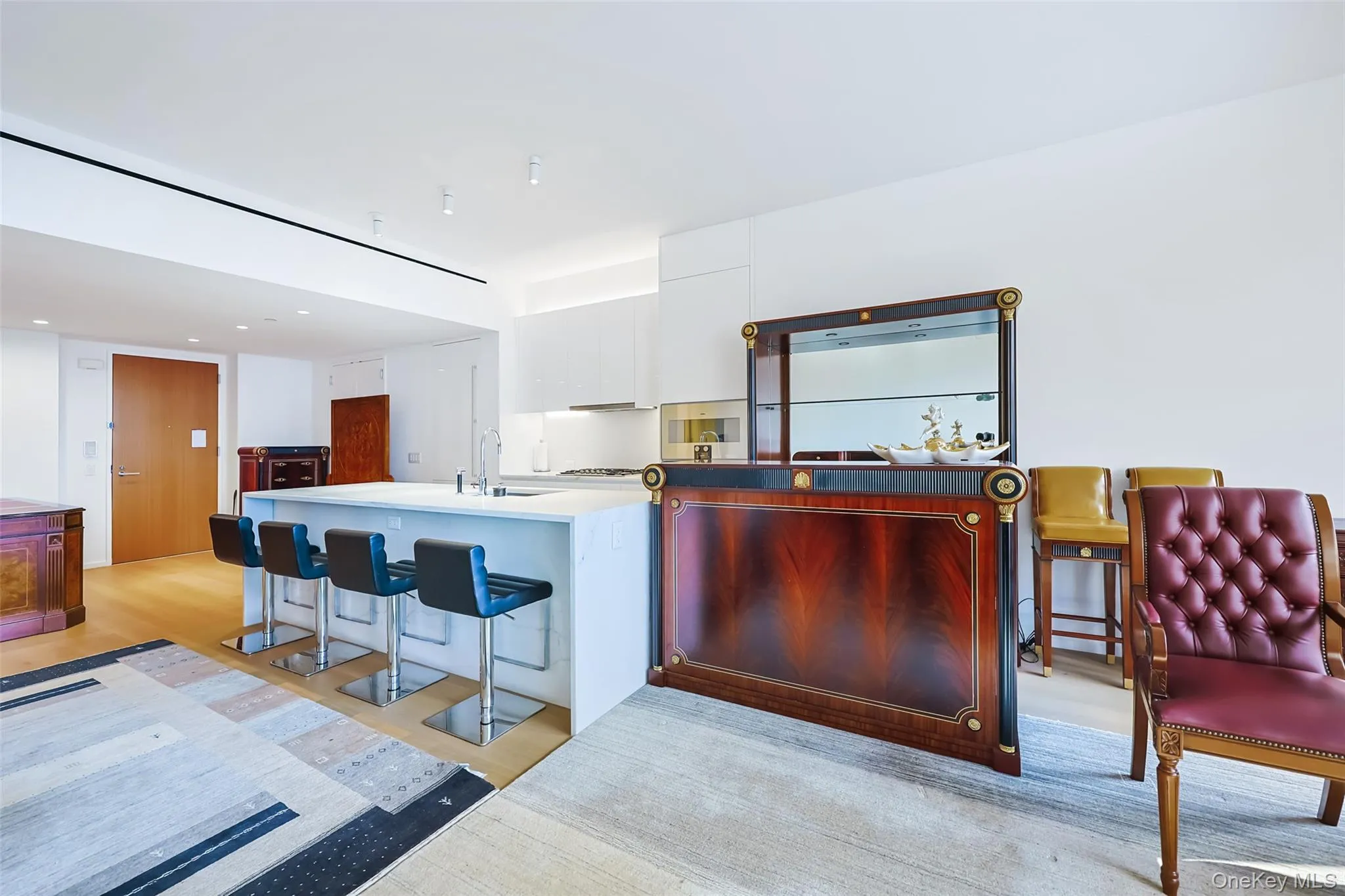 Breakfast Bar Featuring custom Italian white lacquer cabinetry, Calacatta Lincoln marble countertops, natural stone finishes with waterfall edges Breakfast Bar Featuring custom Italian white lacquer cabinetry, Calacatta Lincoln marble countertops, natural stone finishes with waterfall edges