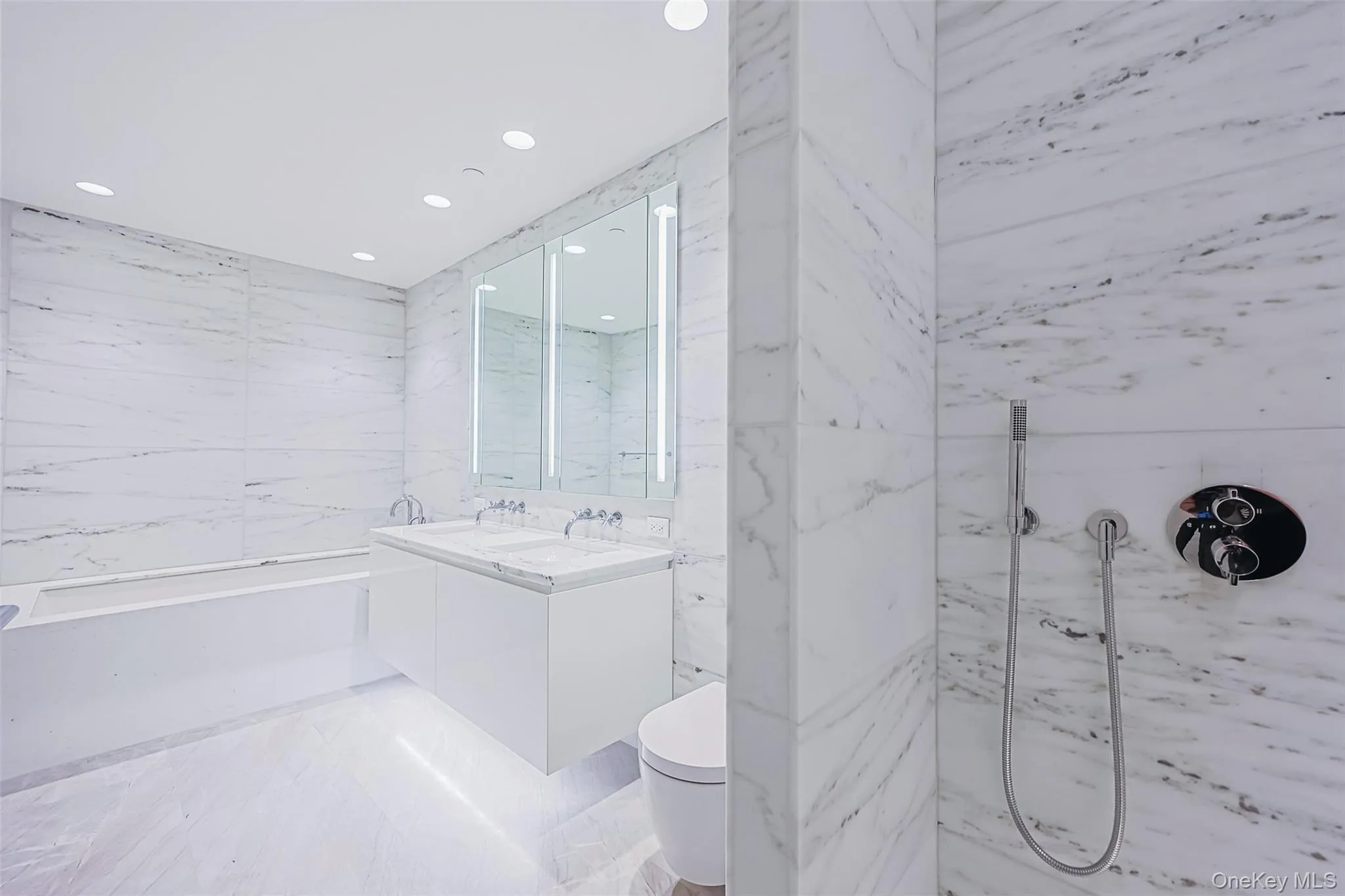Primary Bathroom Spa-inspired bathrooms feature Blue de Savoie stone floors, Calacatta Lincoln marble walls, oversized walk-in showers, and meticulously crafted custom fixtures and finishes Primary Bathroom Spa-inspired bathrooms feature Blue de Savoie stone floors, Calacatta Lincoln marble walls, oversized walk-in showers, and meticulously crafted custom fixtures and finishes