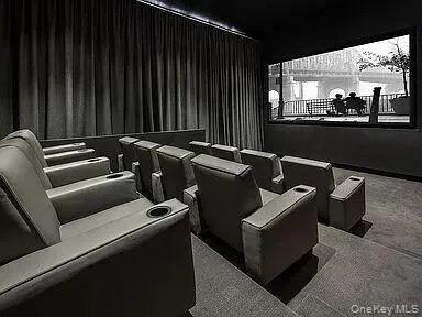 Dedicated theater featuring tiered seating, individual recliners with cupholders, a large projection screen located in Common Area on 2nd Floor Dedicated theater featuring tiered seating, individual recliners with cupholders, a large projection screen located in Common Area on 2nd Floor