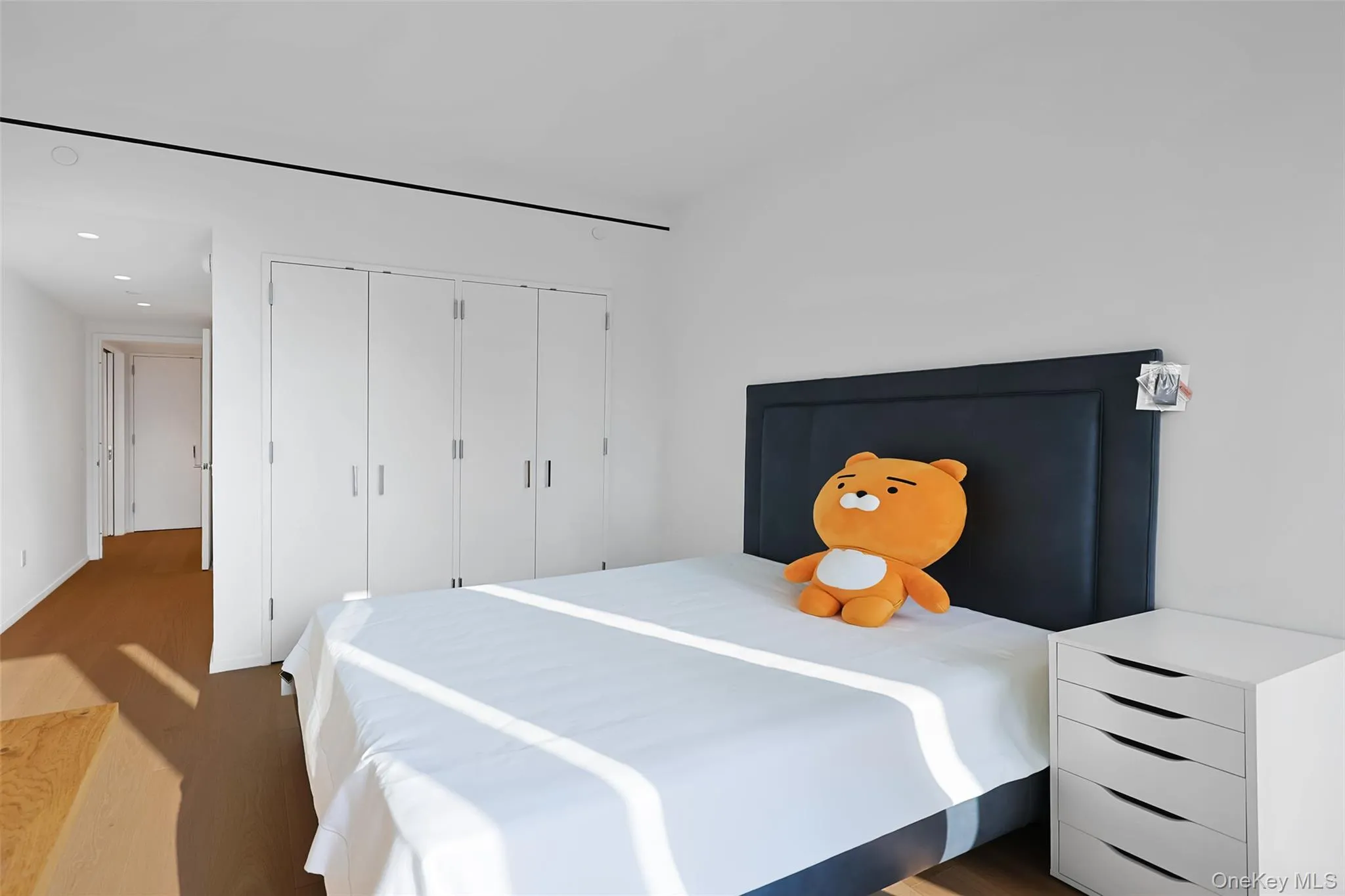 Second Bedroom Bright interior space featuring a white wall, wood-finish flooring, recessed lighting Second Bedroom Bright interior space featuring a white wall, wood-finish flooring, recessed lighting