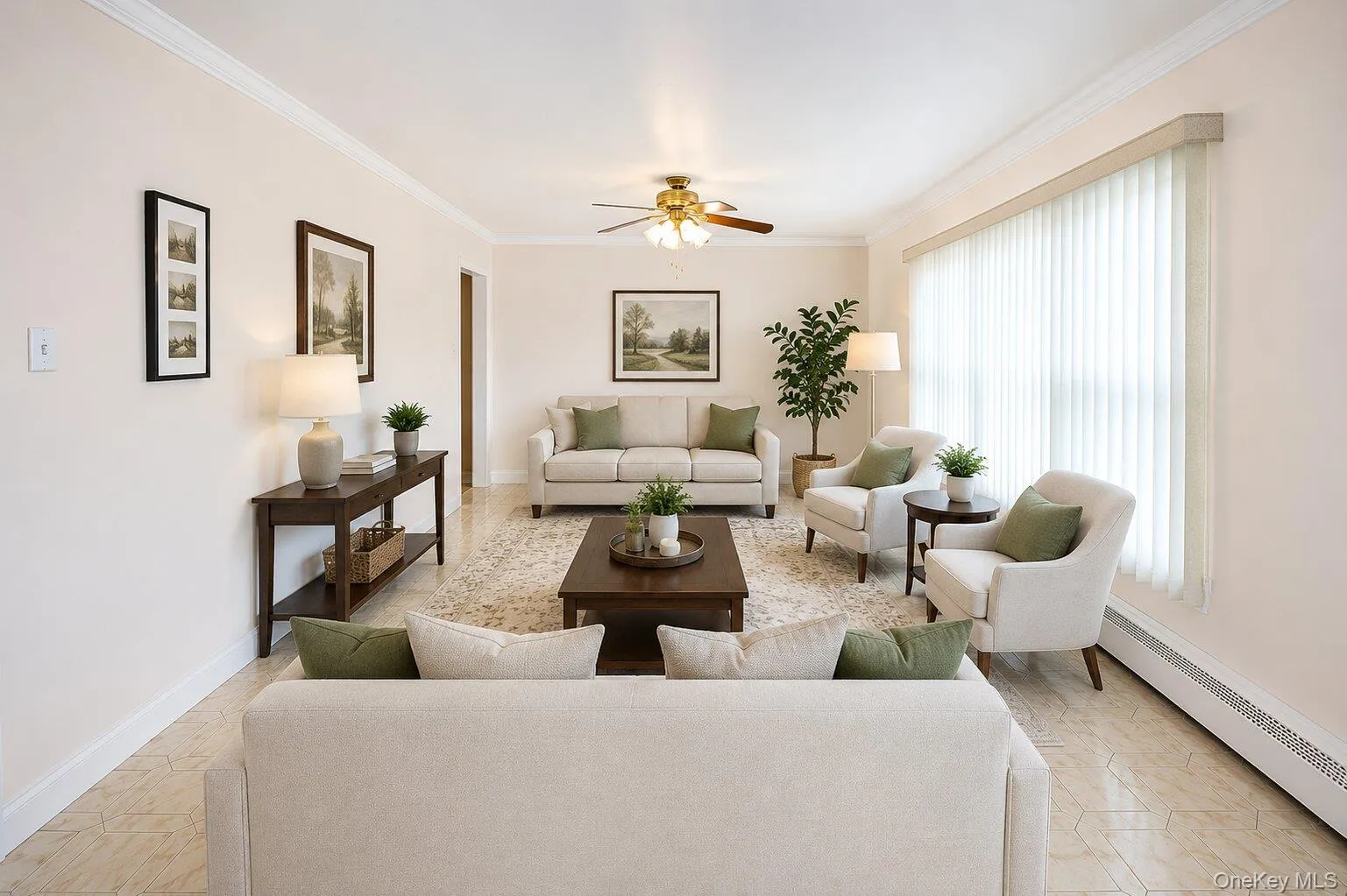 VIRTUALLY STAGED. Spacious living area featuring light-toned walls, crown molding, and tiled flooring VIRTUALLY STAGED. Spacious living area featuring light-toned walls, crown molding, and tiled flooring