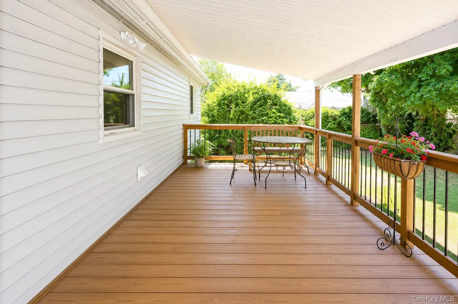 Covered outdoor deck with wood-finish flooring Covered outdoor deck with wood-finish flooring