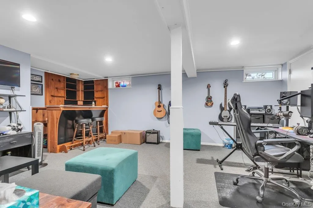 Partially finished basement with a built-in bar. Partially finished basement with a built-in bar.