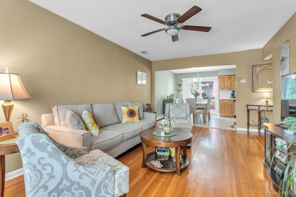A sun-filled living room leads into an eat-in kitchen. A sun-filled living room leads into an eat-in kitchen.