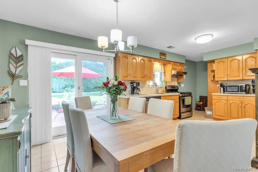 Large eat-in kitchen with sliding doors leading to the backyard and patio. Large eat-in kitchen with sliding doors leading to the backyard and patio.