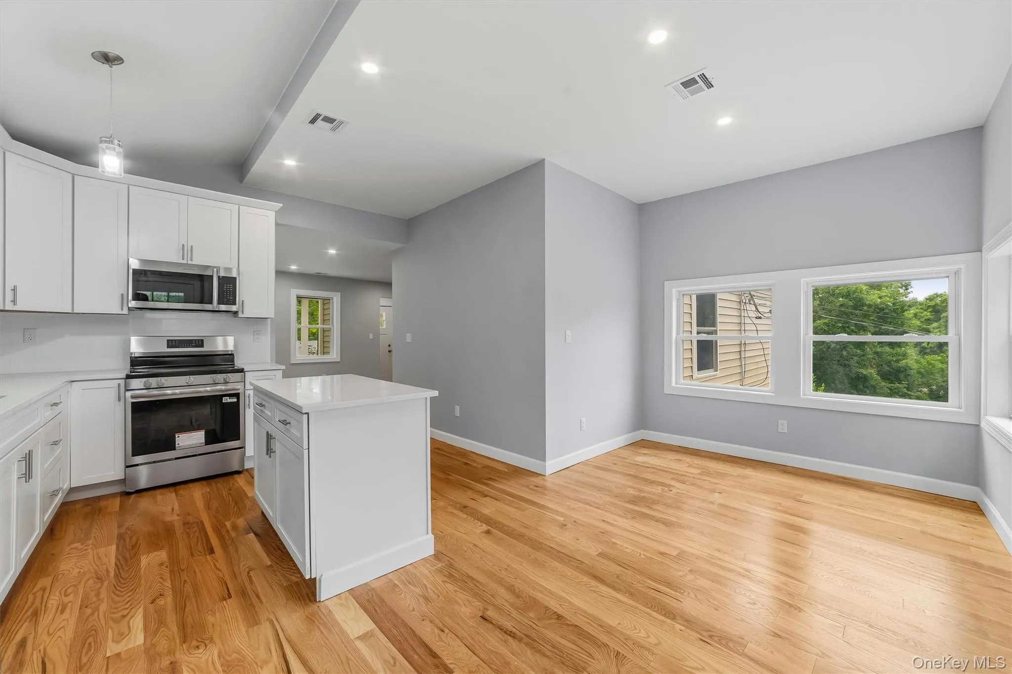 Totally new EIK with SS appliances, Quartz counter tops, island & door to porch Totally new EIK with SS appliances, Quartz counter tops, island & door to porch