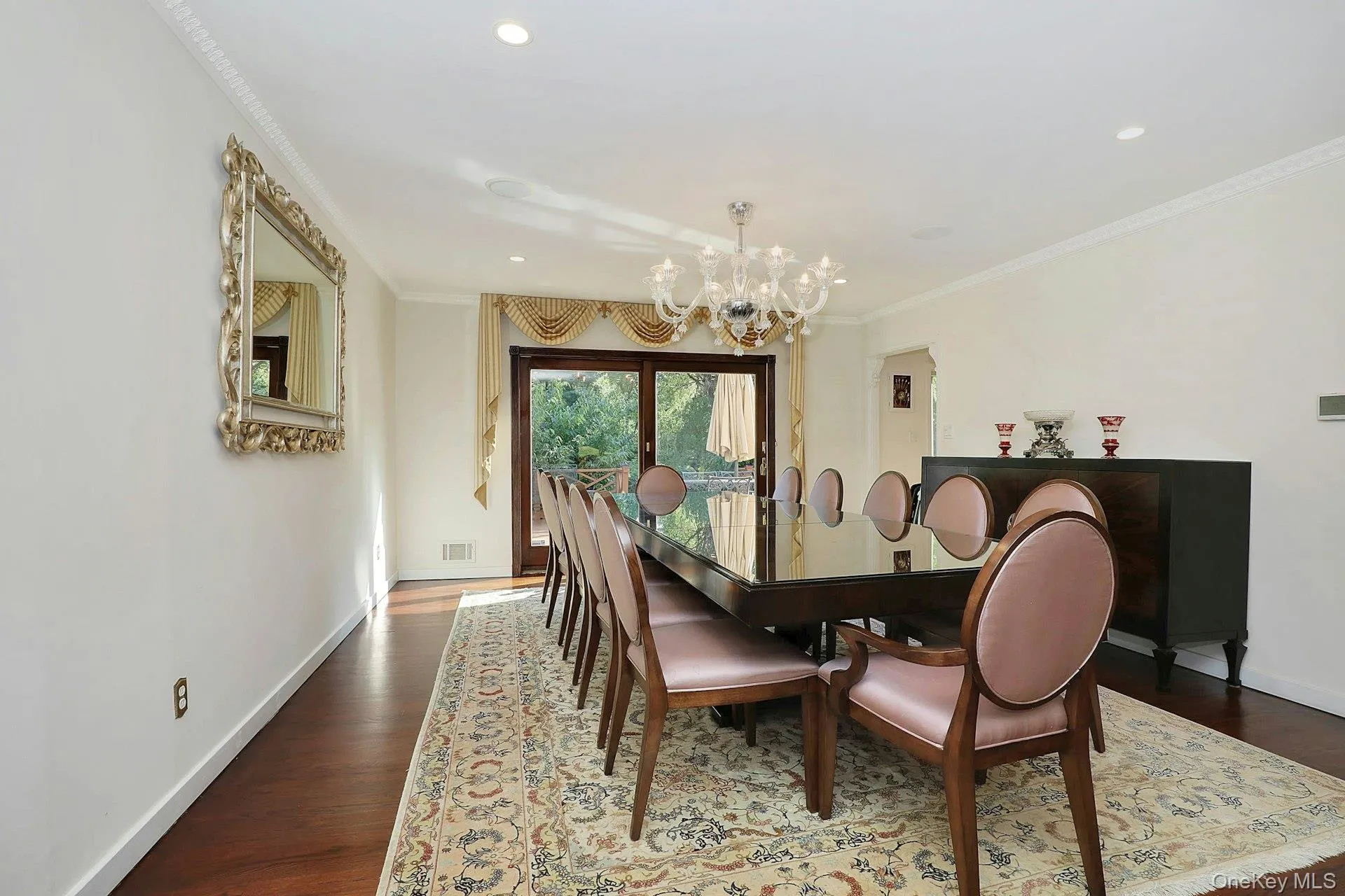Large dining room with sunlit doors leading to the deck and backyard Large dining room with sunlit doors leading to the deck and backyard