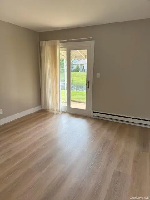 Large living room with sliding door access to patio and lagoon view. Large living room with sliding door access to patio and lagoon view.