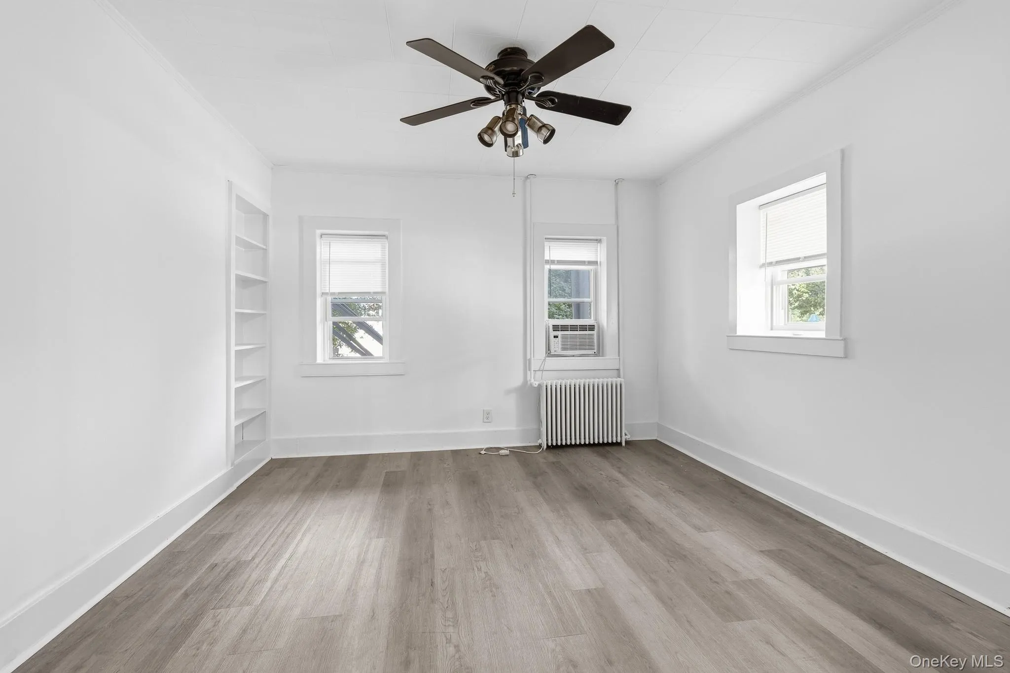 The main bedroom gets plenty of light, features built-in shelving and beautiful new floors. The main bedroom gets plenty of light, features built-in shelving and beautiful new floors.